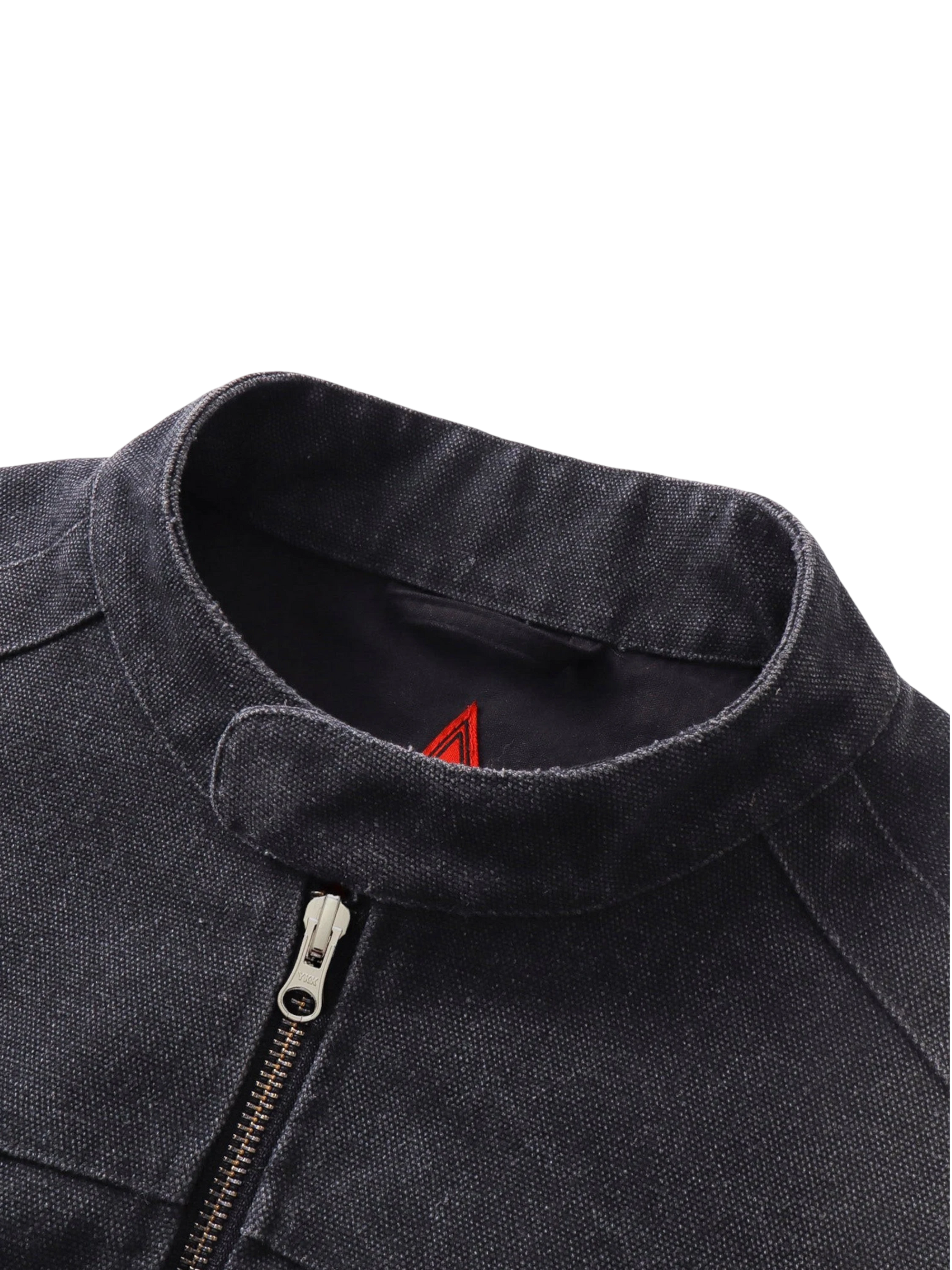 Close-up of the stand collar and zip cuff on TBHNP black canvas moto jacket — men's streetwear detail