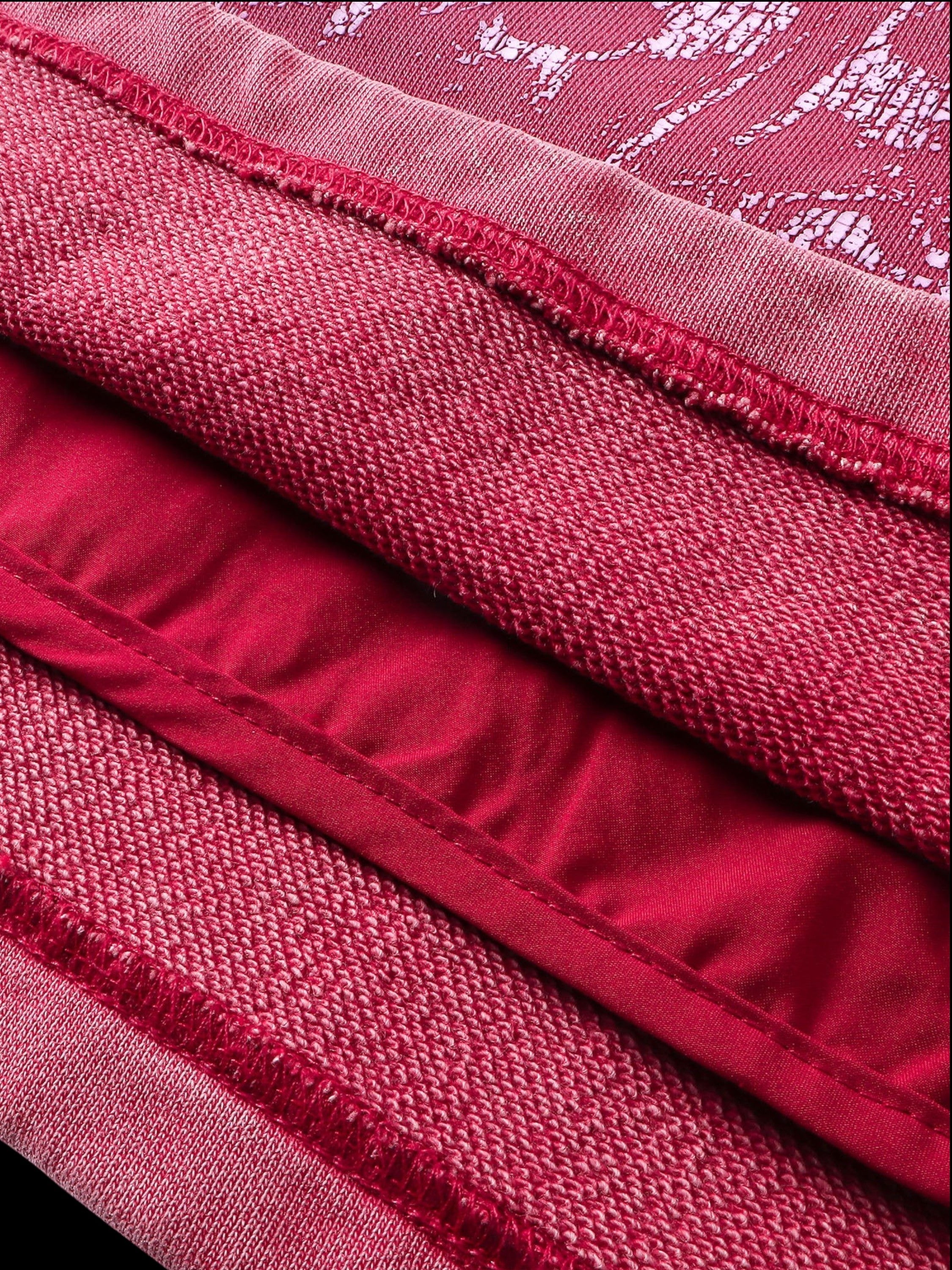 Close-up of the no-rib hem and side pocket on TBHNP red hoodie — men's streetwear detail