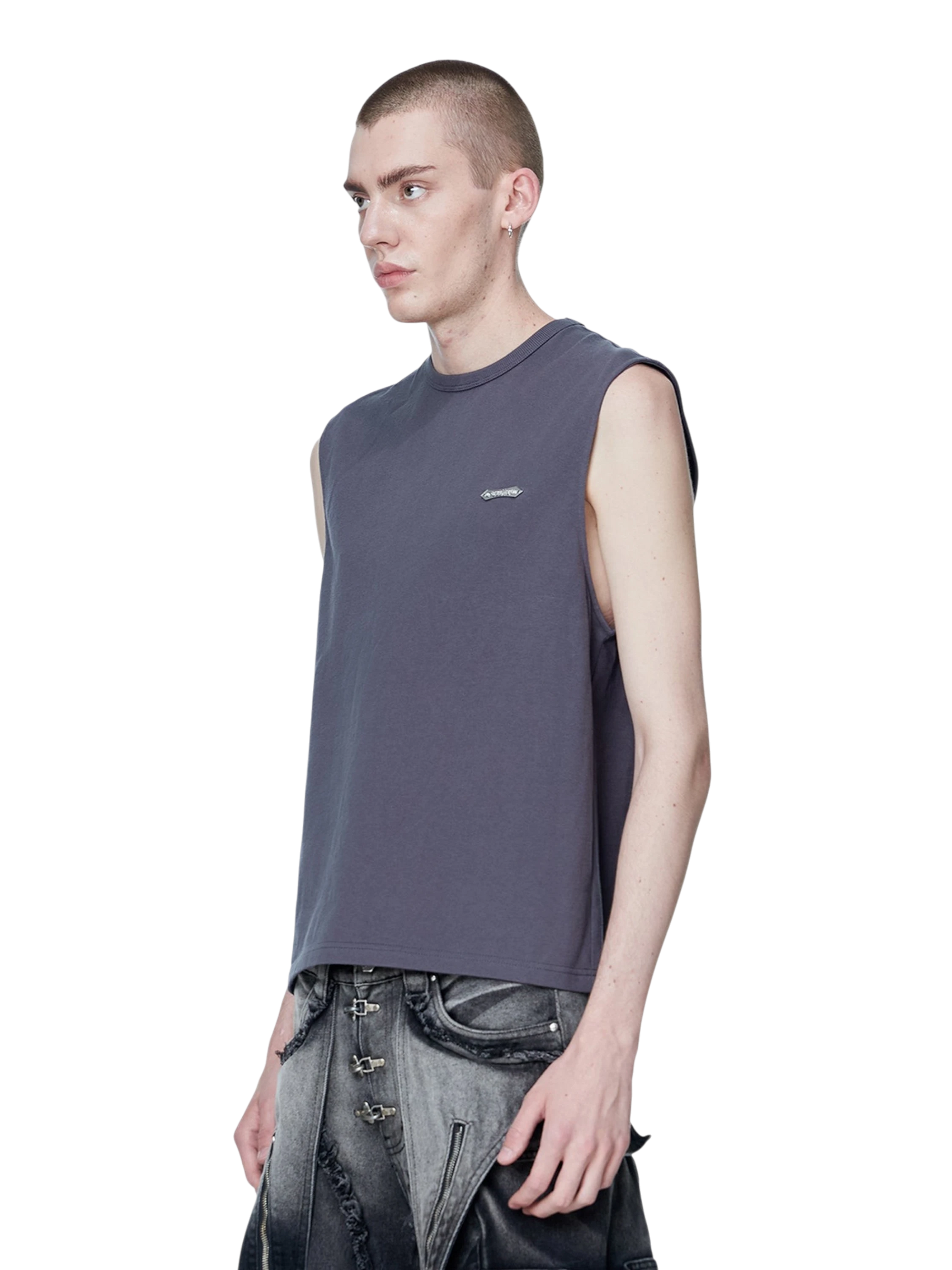 Model styling TBHNP dark grey Shadowbat vest, front detail — men's streetwear sleeveless tee