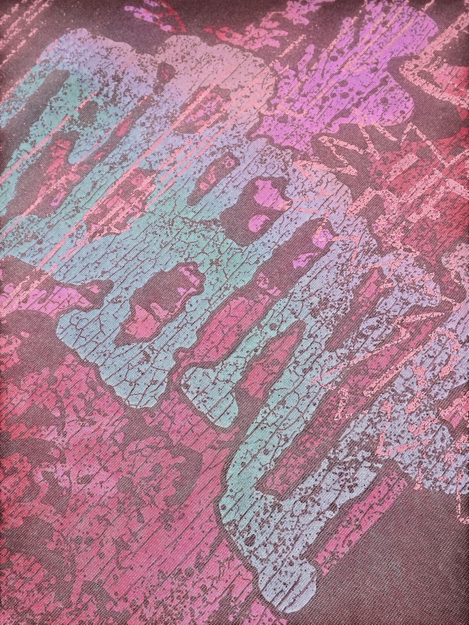 Close-up of the print and destroyed holes on TBHNP burgundy Wraith Sorcerer tee — men's streetwear detail