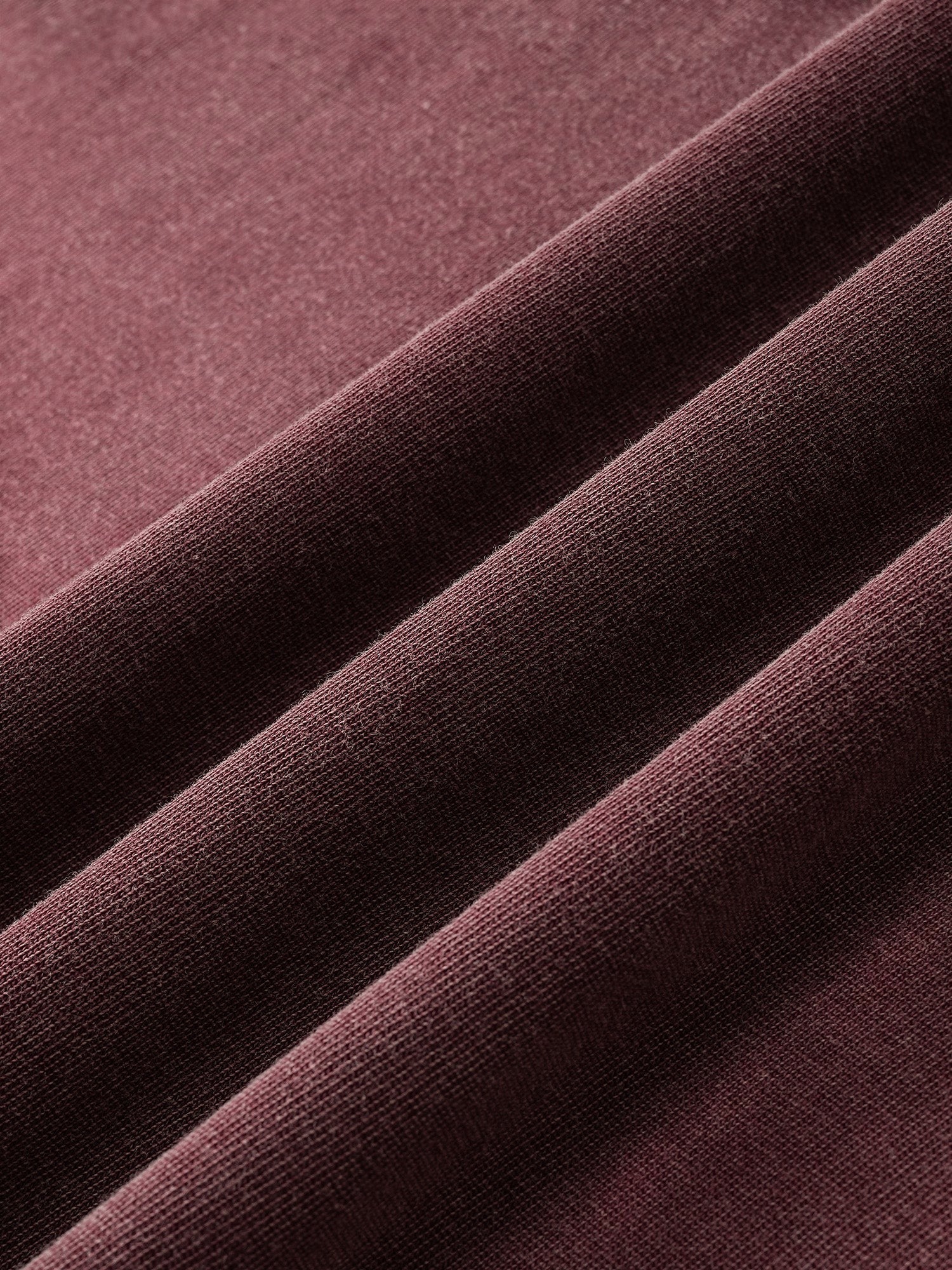 Close-up of the cotton fabric texture on TBHNP burgundy Wraith Sorcerer tee — men's streetwear detail