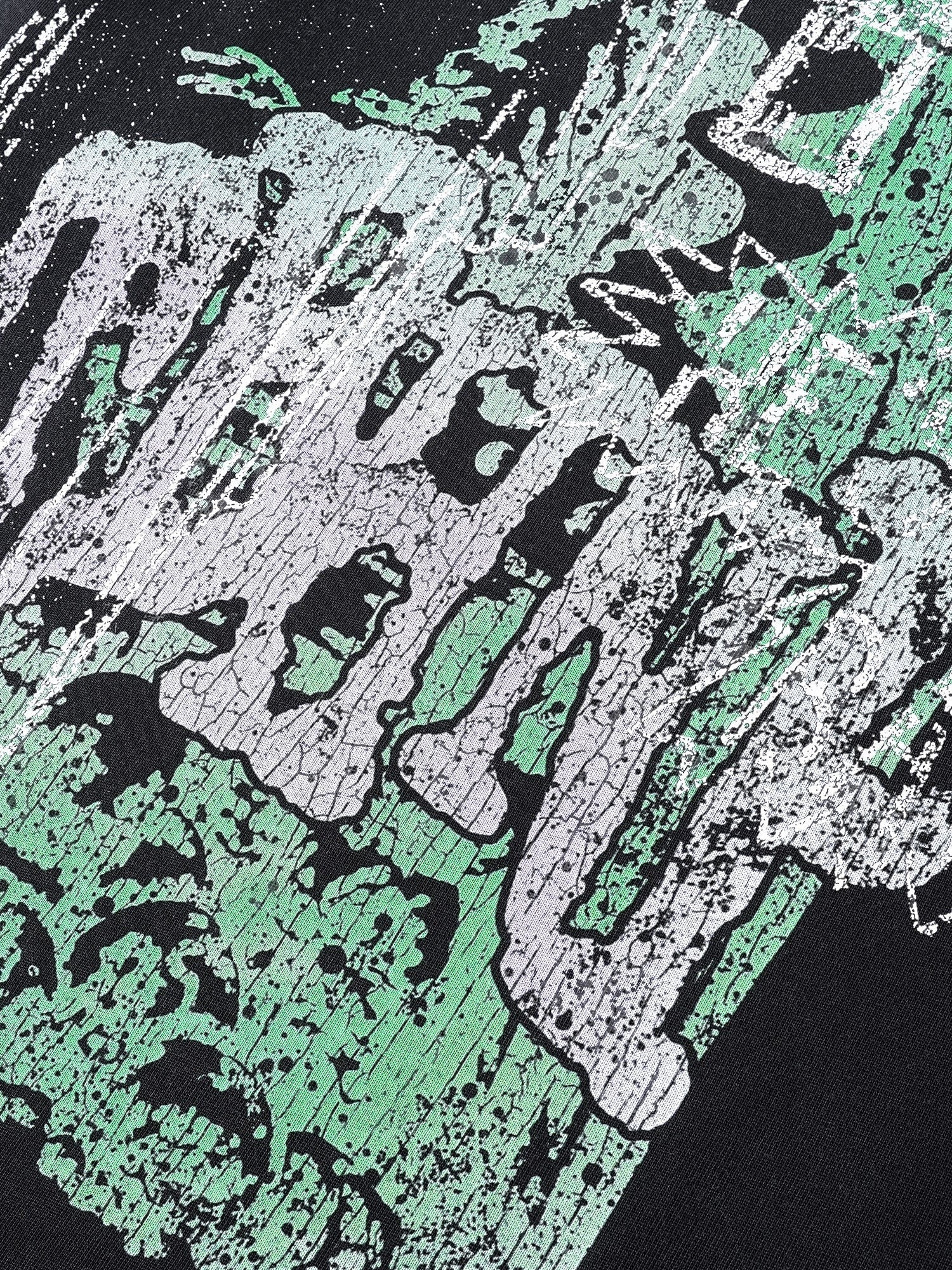 Close-up of the green Wraith Sorcerer print on TBHNP black tee — men's streetwear detail