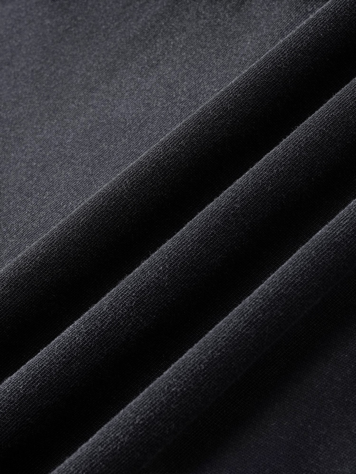 Close-up of the washed cotton fabric on TBHNP black Wraith Sorcerer tee — men's streetwear detail