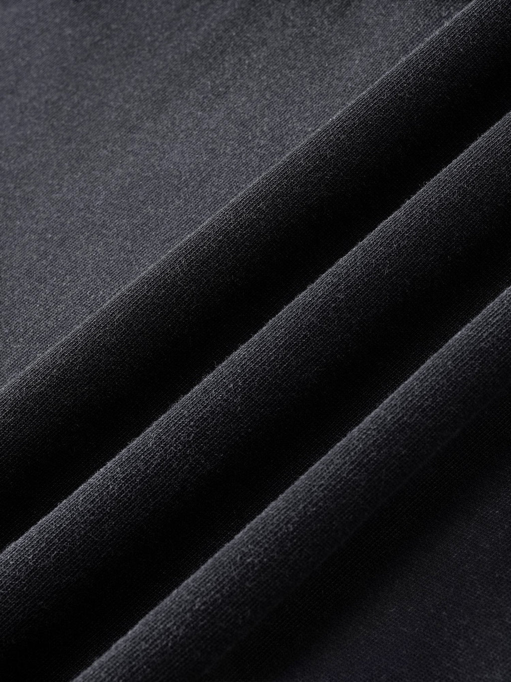Close-up of the washed cotton fabric on TBHNP black Wraith Sorcerer tee — men's streetwear detail