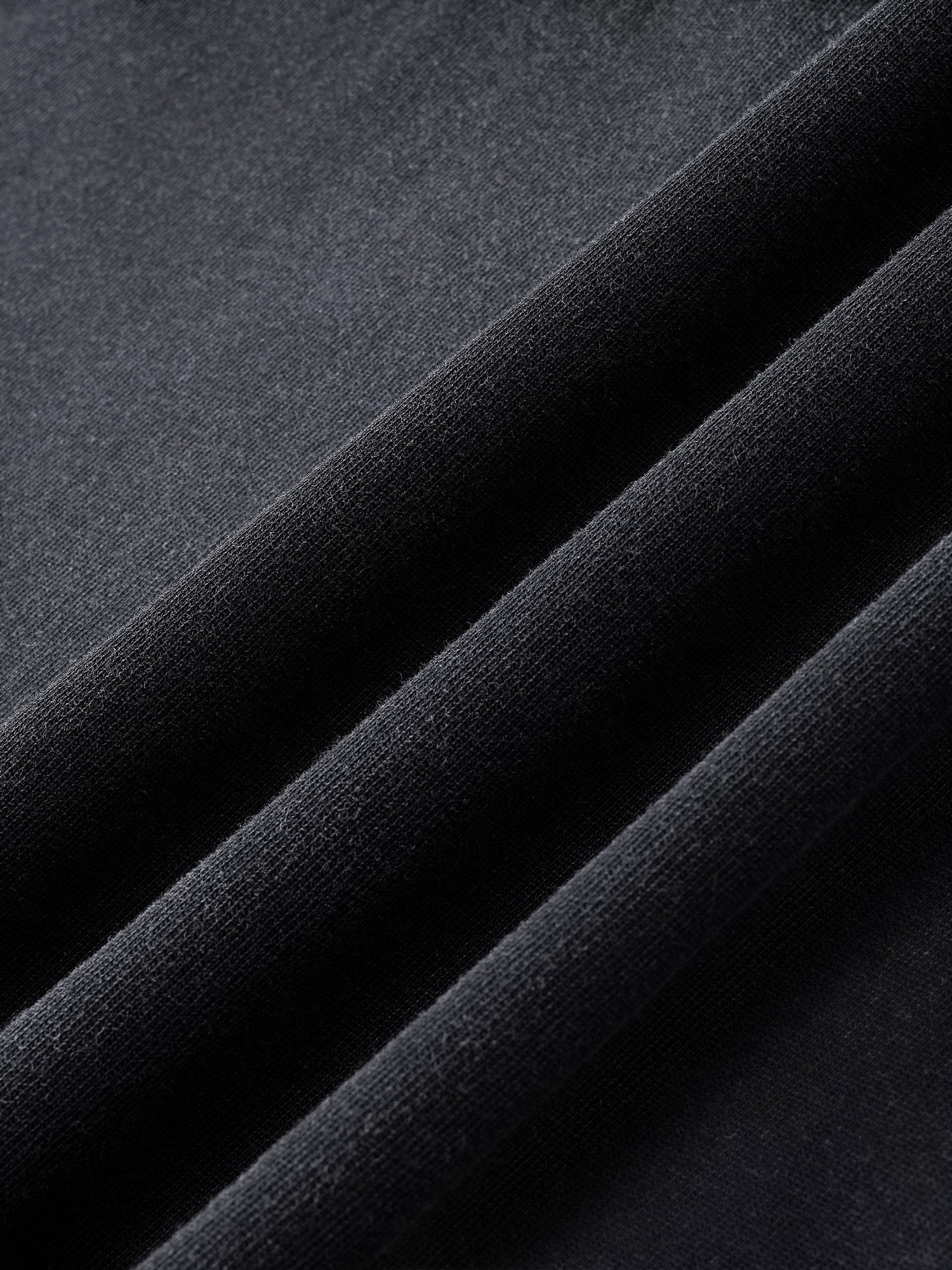 Close-up of the washed cotton fabric on TBHNP black Wraith Sorcerer tee — men's streetwear detail