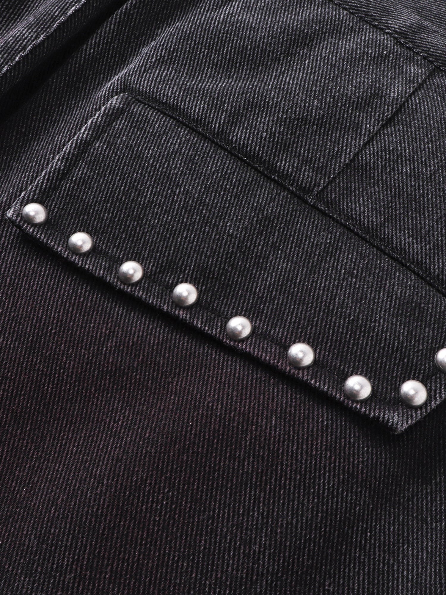 Close-up of the metal studs along the pocket on TBHNP black trousers — men's streetwear detail