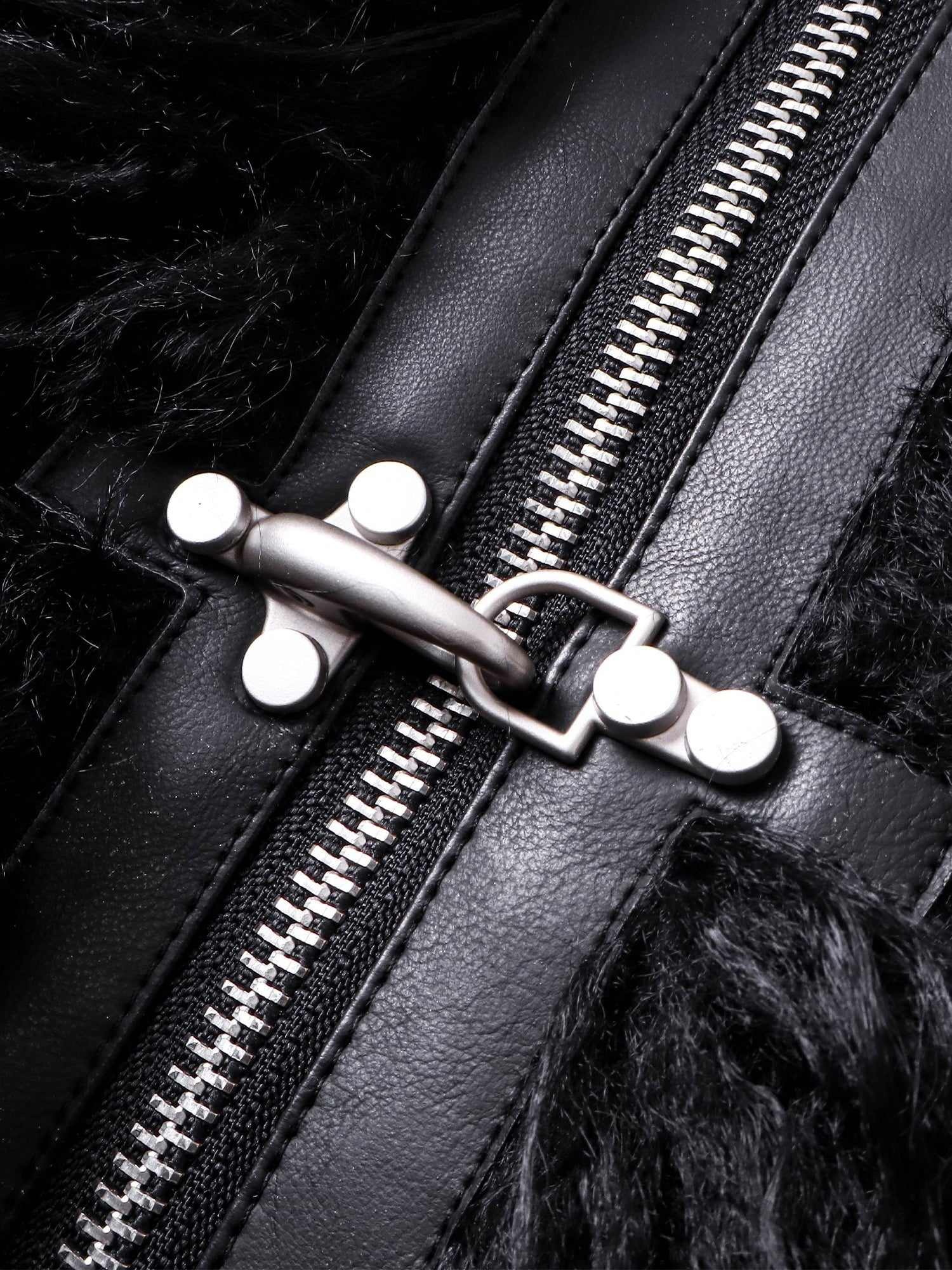 Close-up of the zip and buckle hardware on TBHNP faux-fur bomber — men's streetwear detail