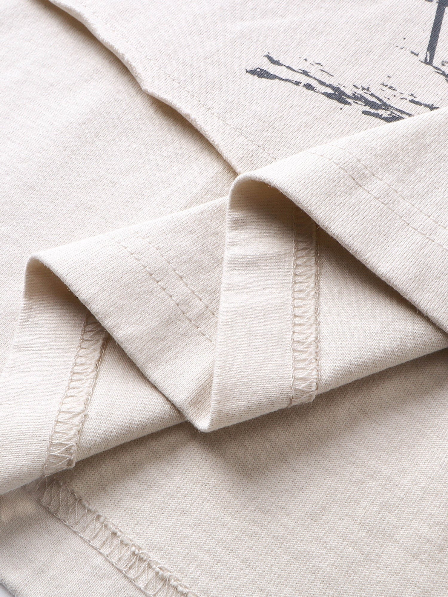 Close-up of the layered cuff hem on TBHNP knight long-sleeve tee — men's streetwear detail