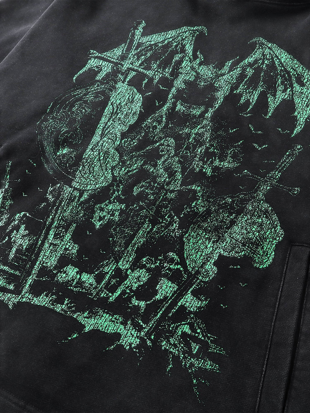 Close-up of the teal knight print on TBHNP black hoodie — men's streetwear detail
