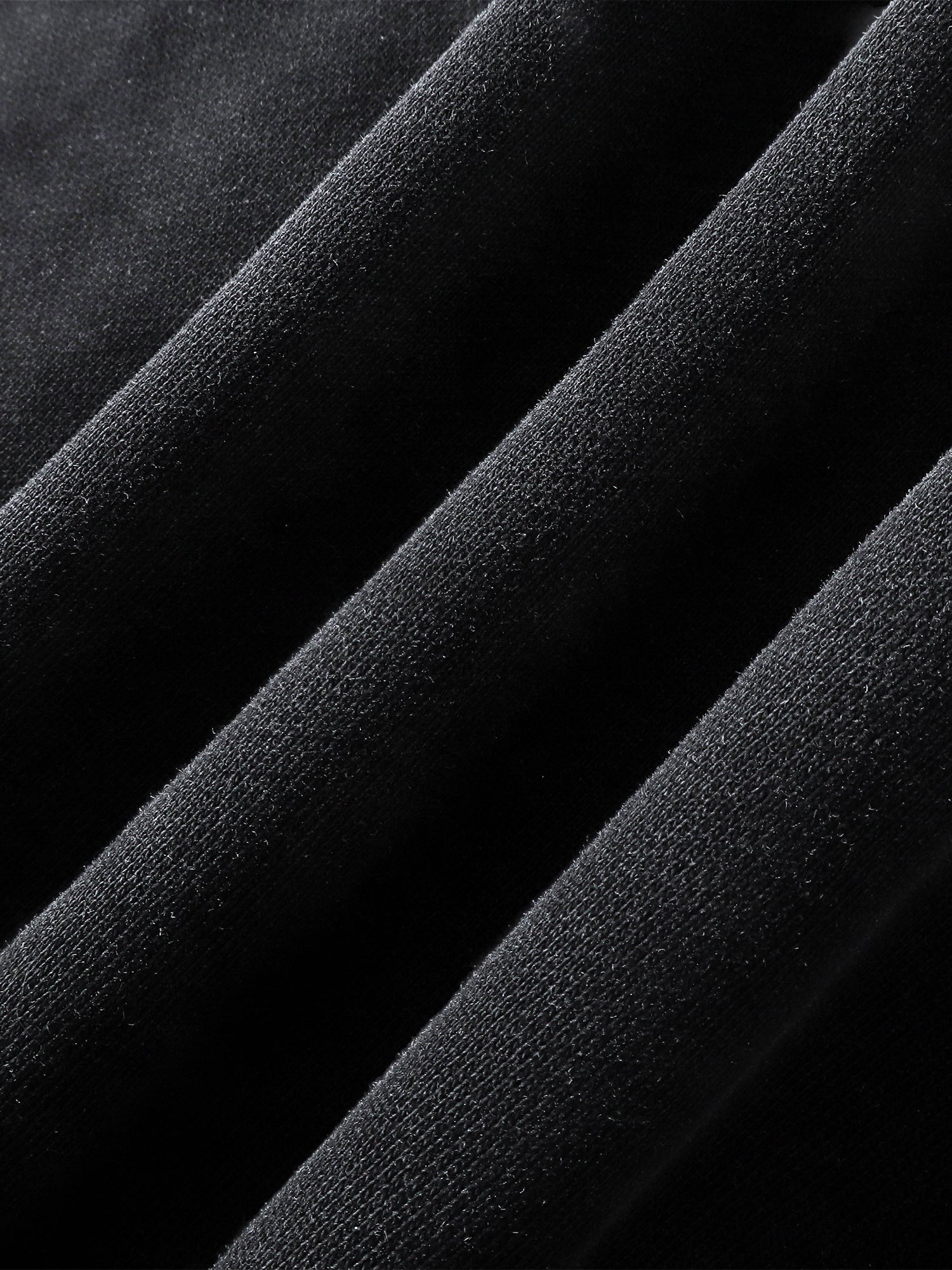 Close-up of the no-rib hem on TBHNP black arrival knight hoodie — men's streetwear detail