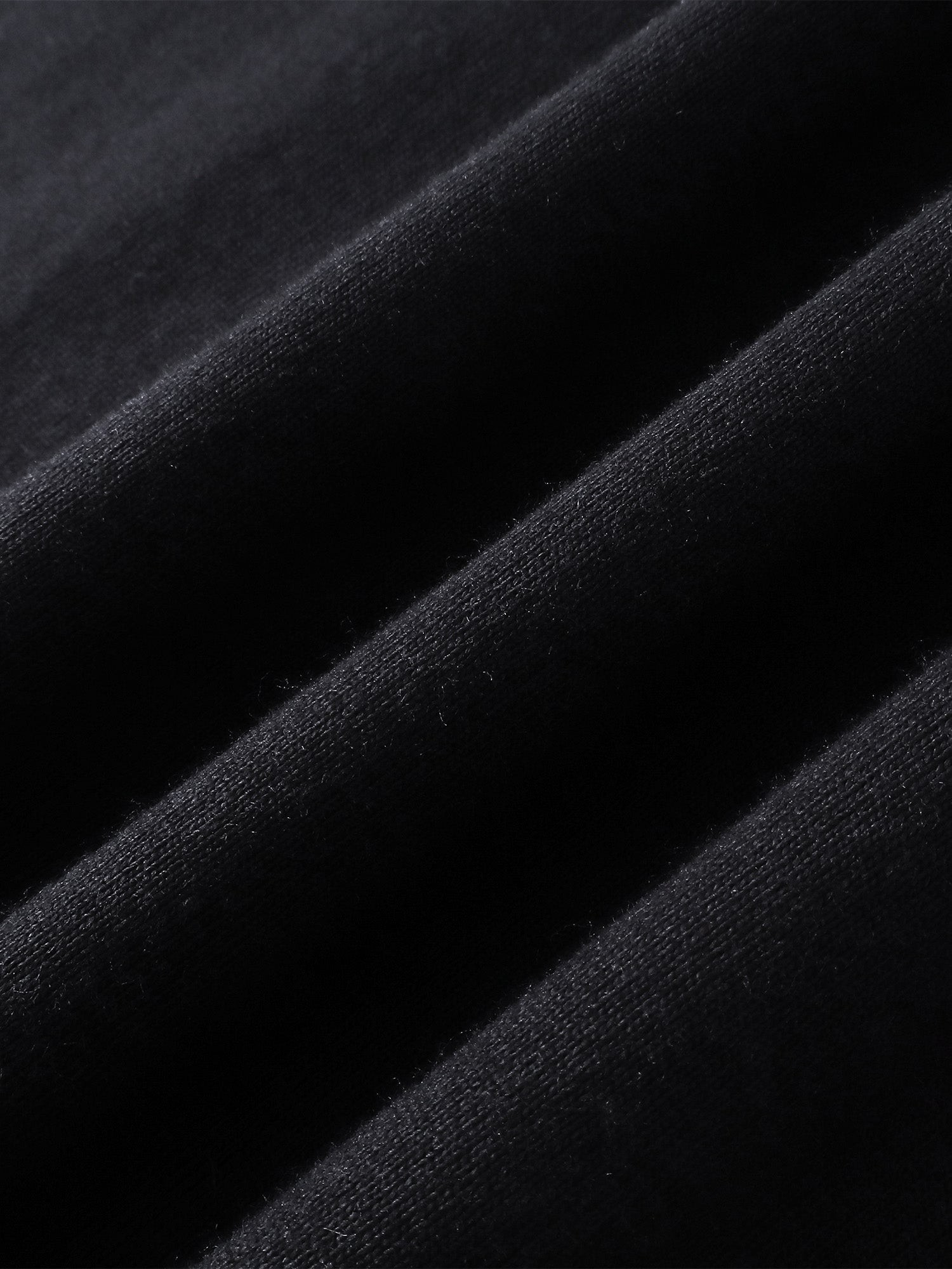 Close-up of the cotton fabric on TBHNP black Shadowbat vest — men's streetwear detail