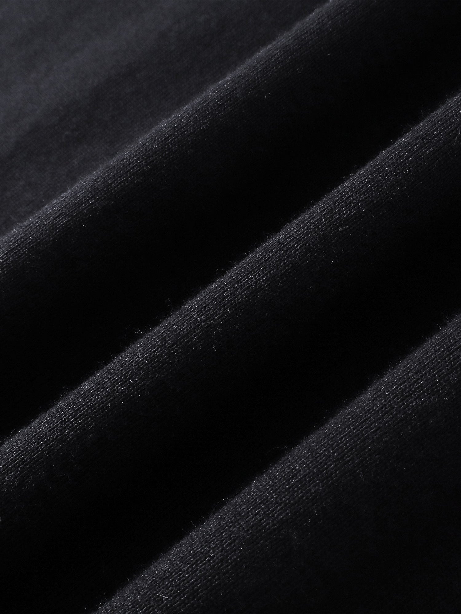 Close-up of the cotton fabric on TBHNP black Shadowbat vest — men's streetwear detail
