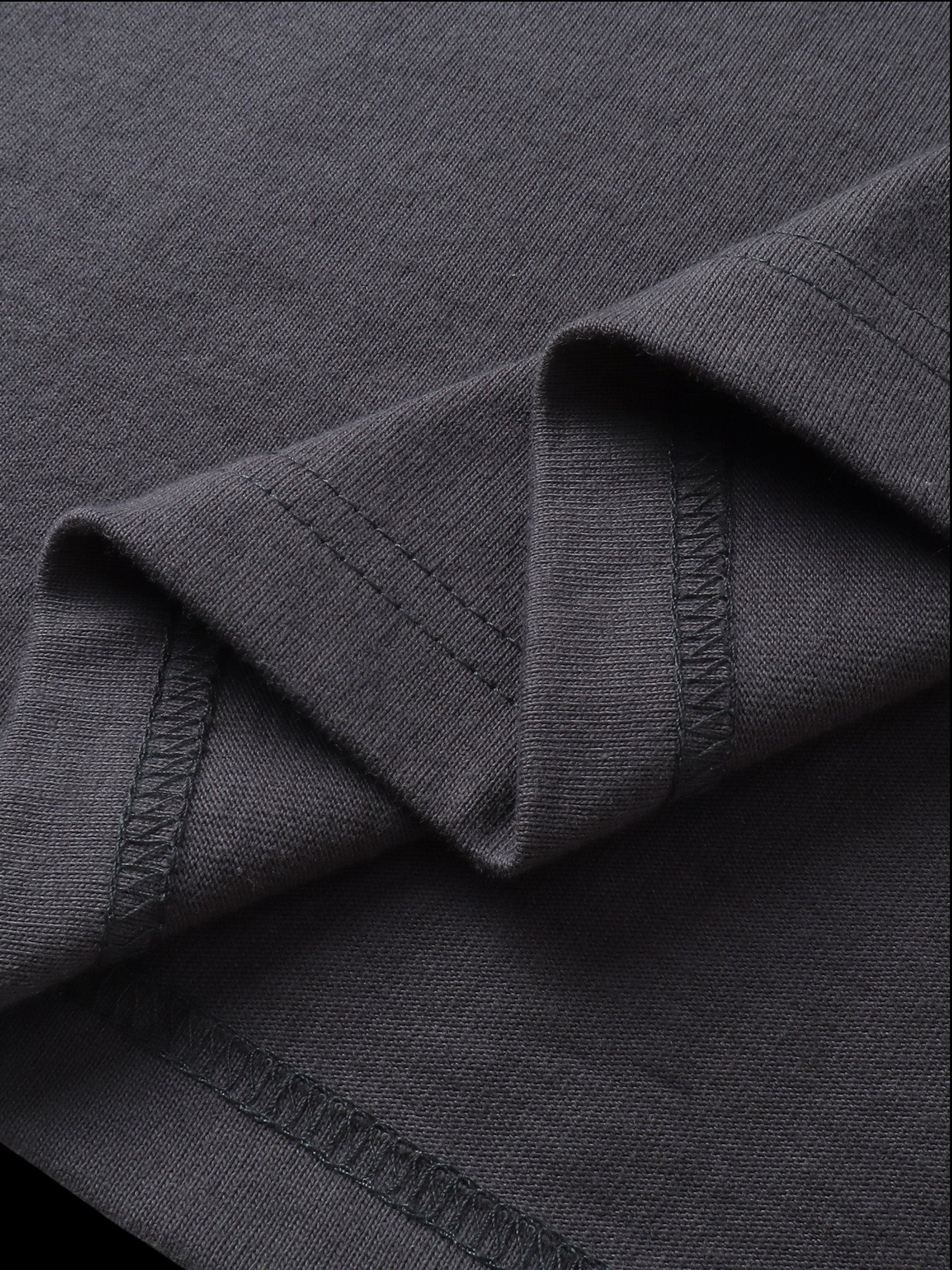 Close-up of the fabric fold on TBHNP dark grey Shadowbat vest — men's streetwear detail