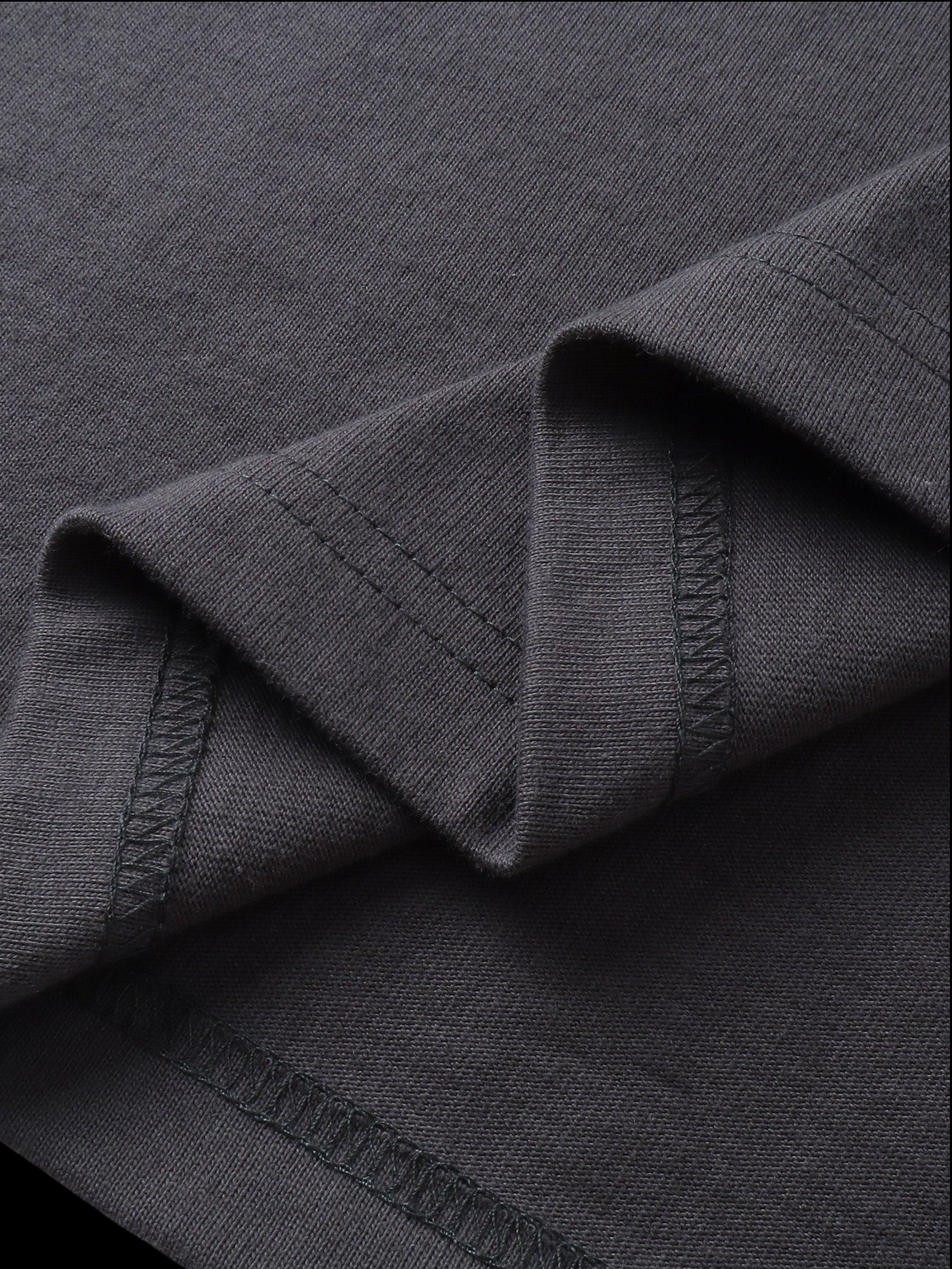 Close-up of the fabric fold on TBHNP dark grey Shadowbat vest — men's streetwear detail