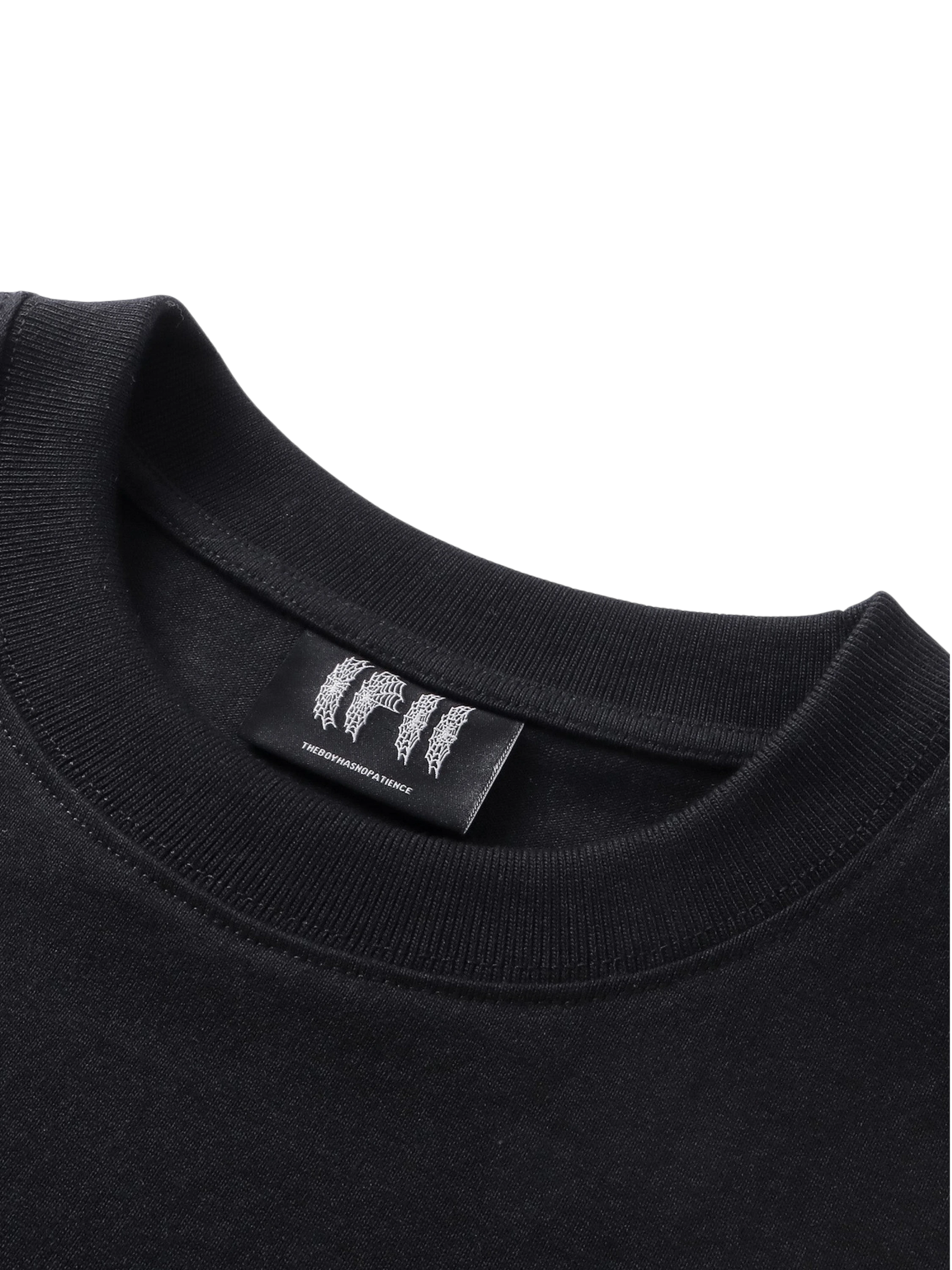 Close-up of the chest emblem on TBHNP black Emblem & Shadowbat tee — men's streetwear detail