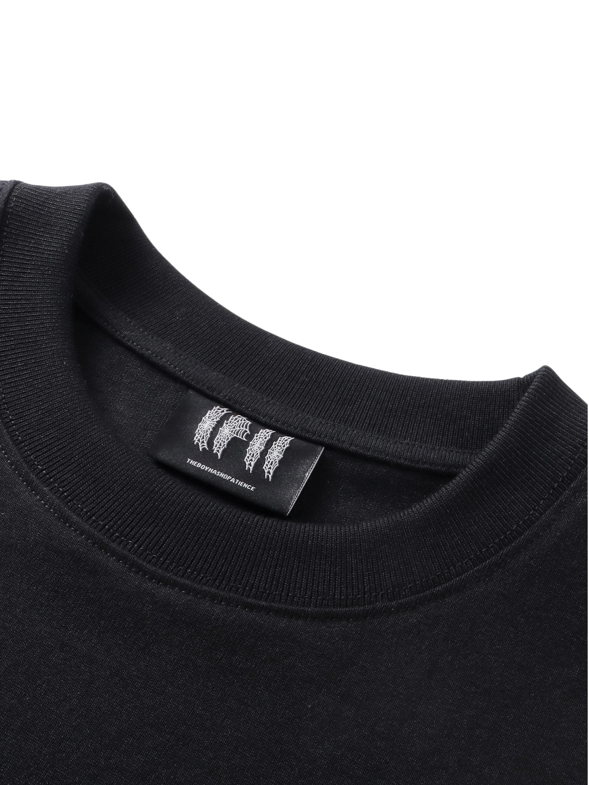 Close-up of the chest emblem on TBHNP black Emblem & Shadowbat tee — men's streetwear detail