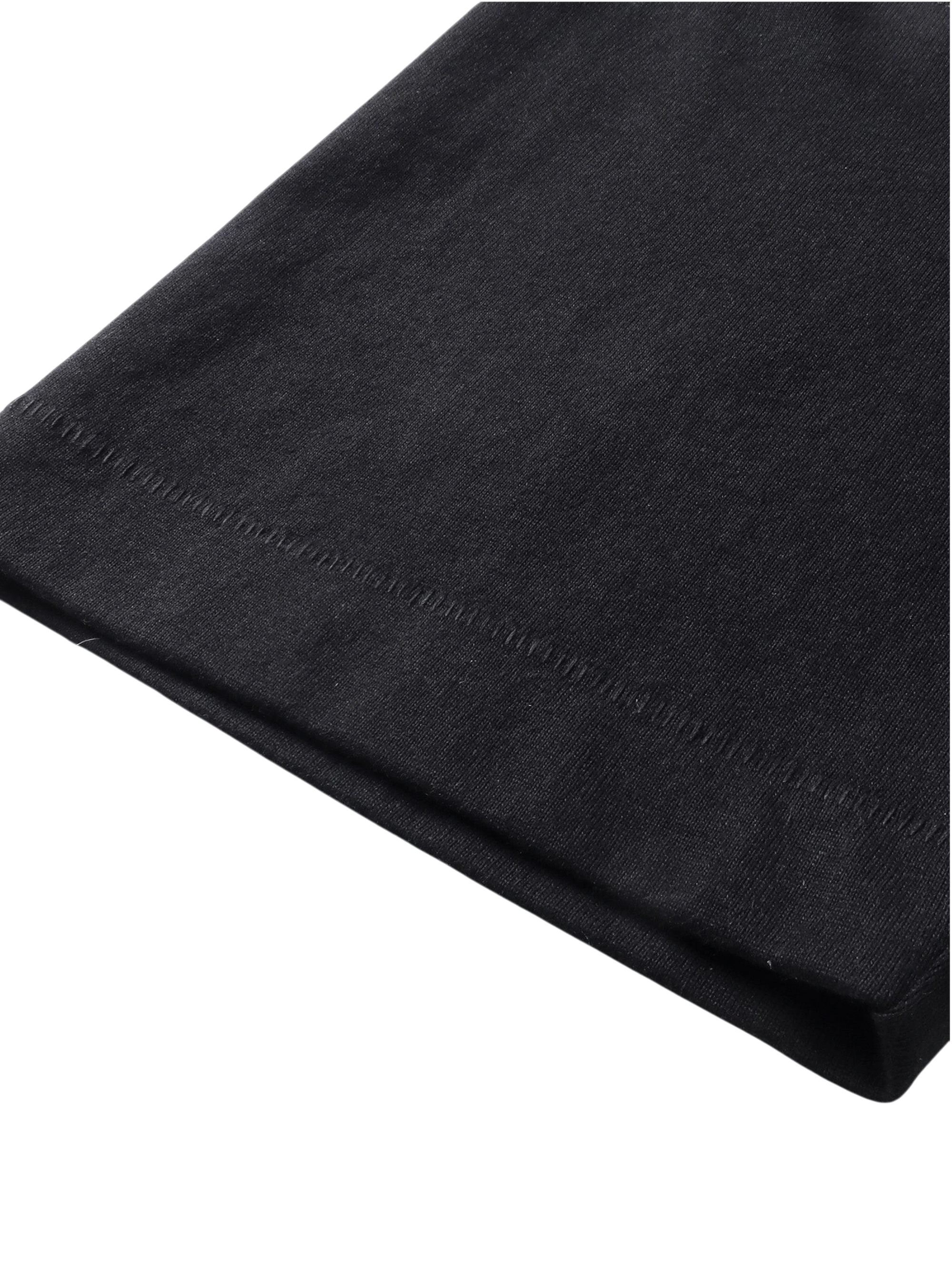 Close-up of the fabric fold on TBHNP black Emblem & Shadowbat tee — men's streetwear detail