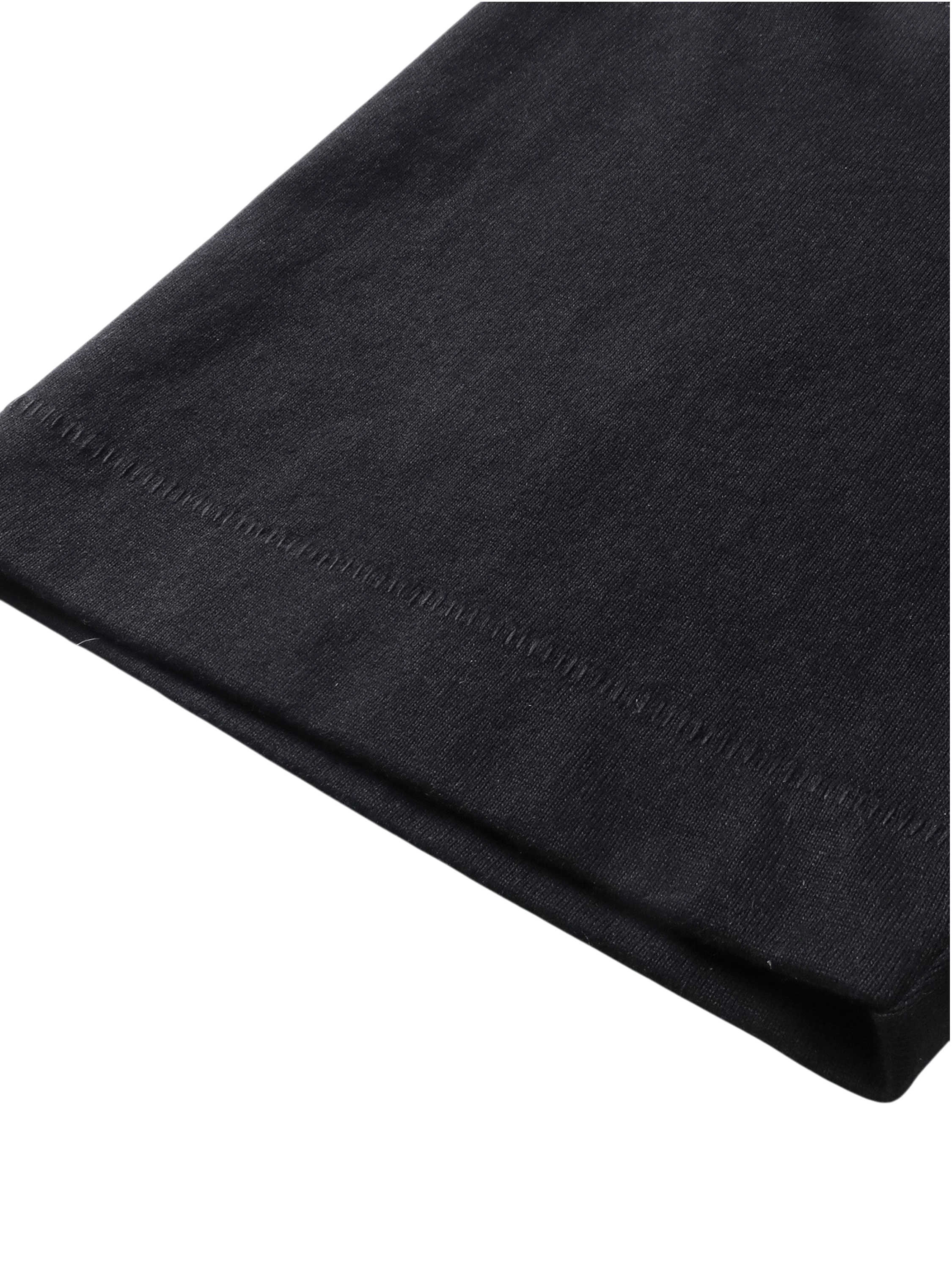 Close-up of the fabric fold on TBHNP black Emblem & Shadowbat tee — men's streetwear detail