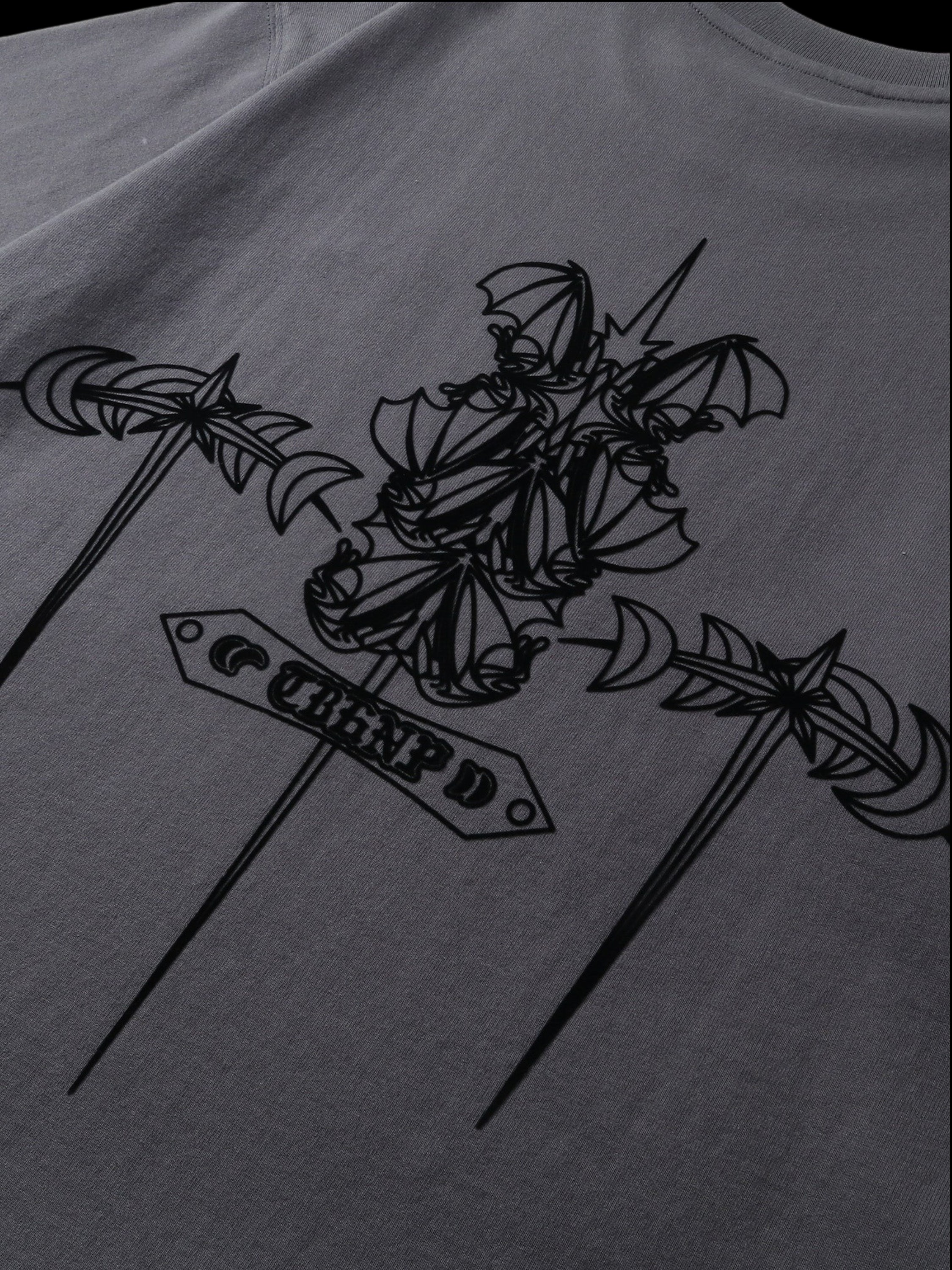 Close-up of the emblem and shadowbat print on TBHNP dark grey tee — men's streetwear detail
