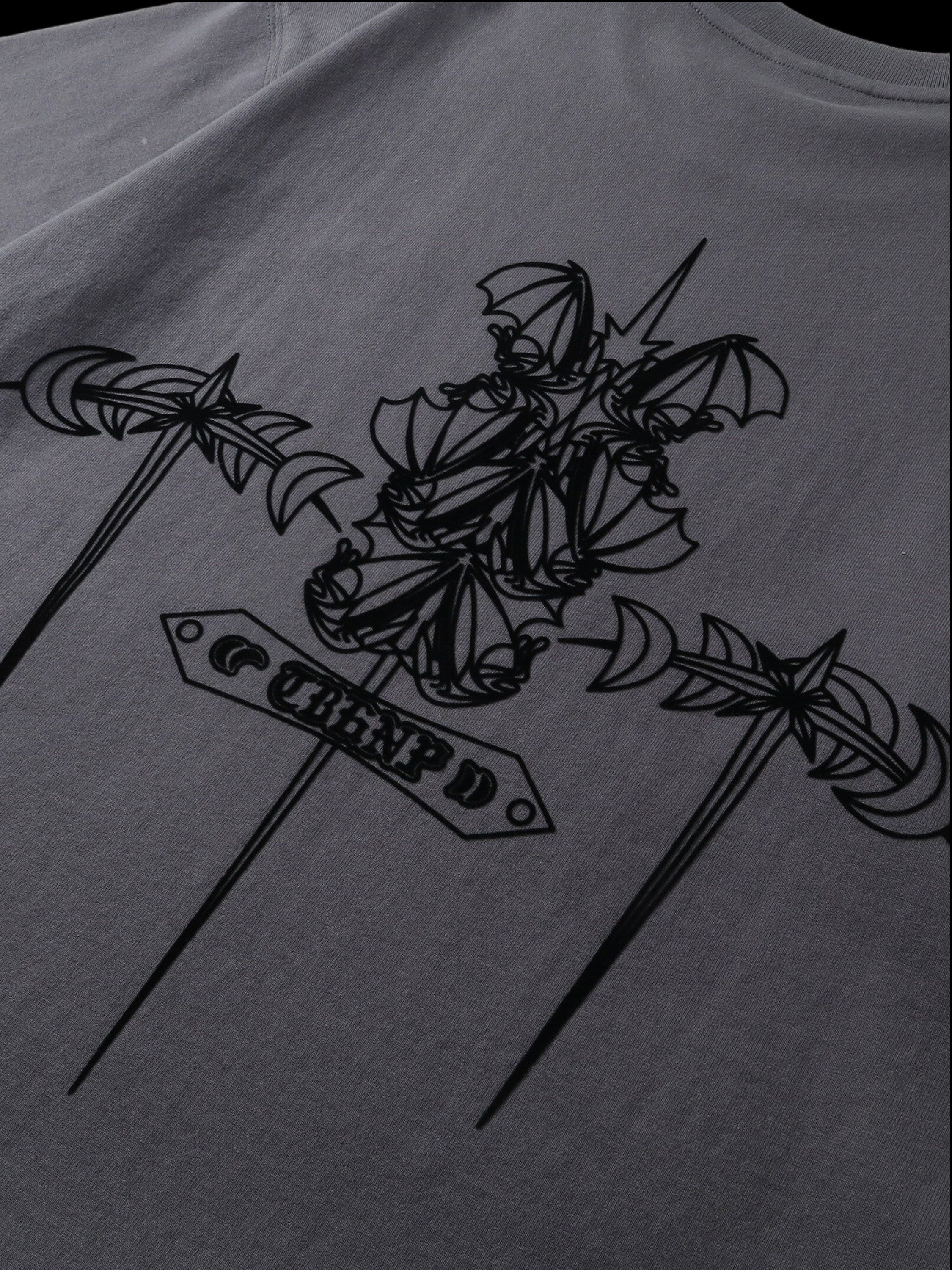 Close-up of the emblem and shadowbat print on TBHNP dark grey tee — men's streetwear detail