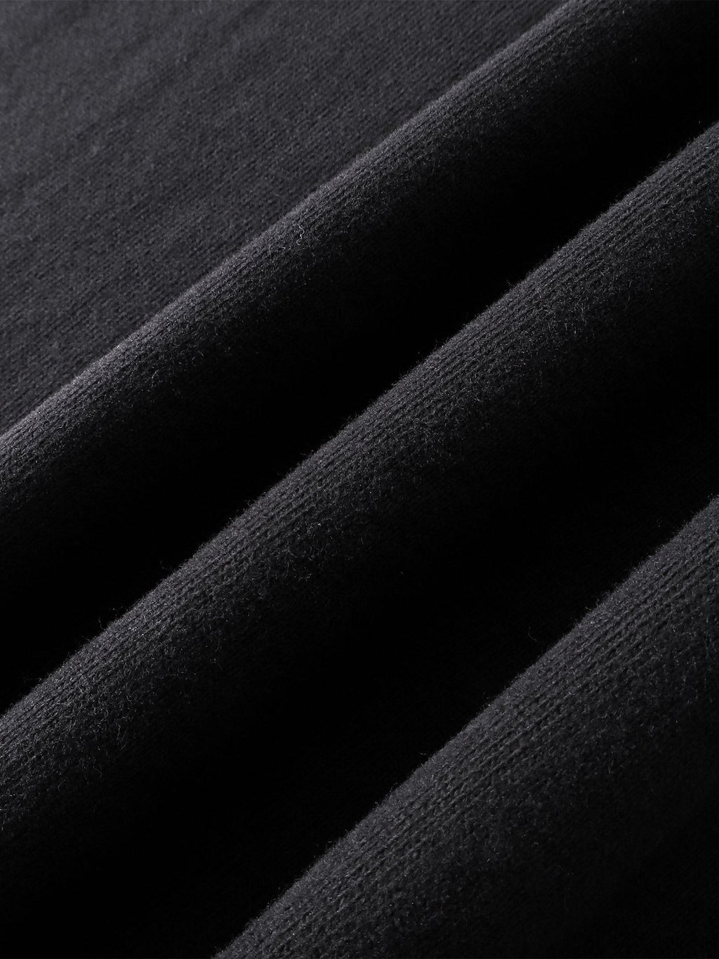 Close-up of the cotton texture on TBHNP dark grey Knight & Sword tee — men's streetwear detail