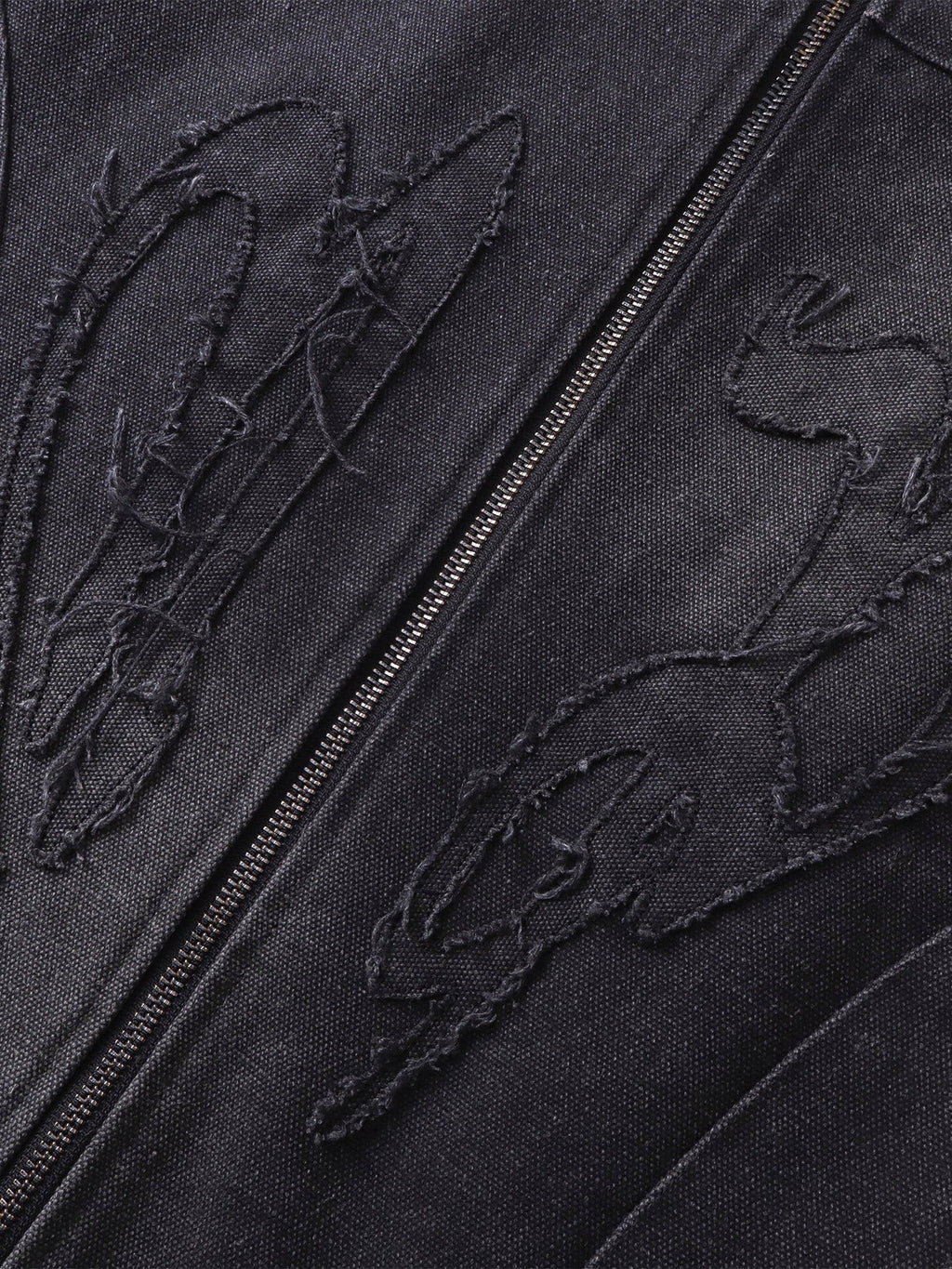 Close-up of the tonal self-fabric embroidery on TBHNP canvas moto jacket — men's streetwear detail