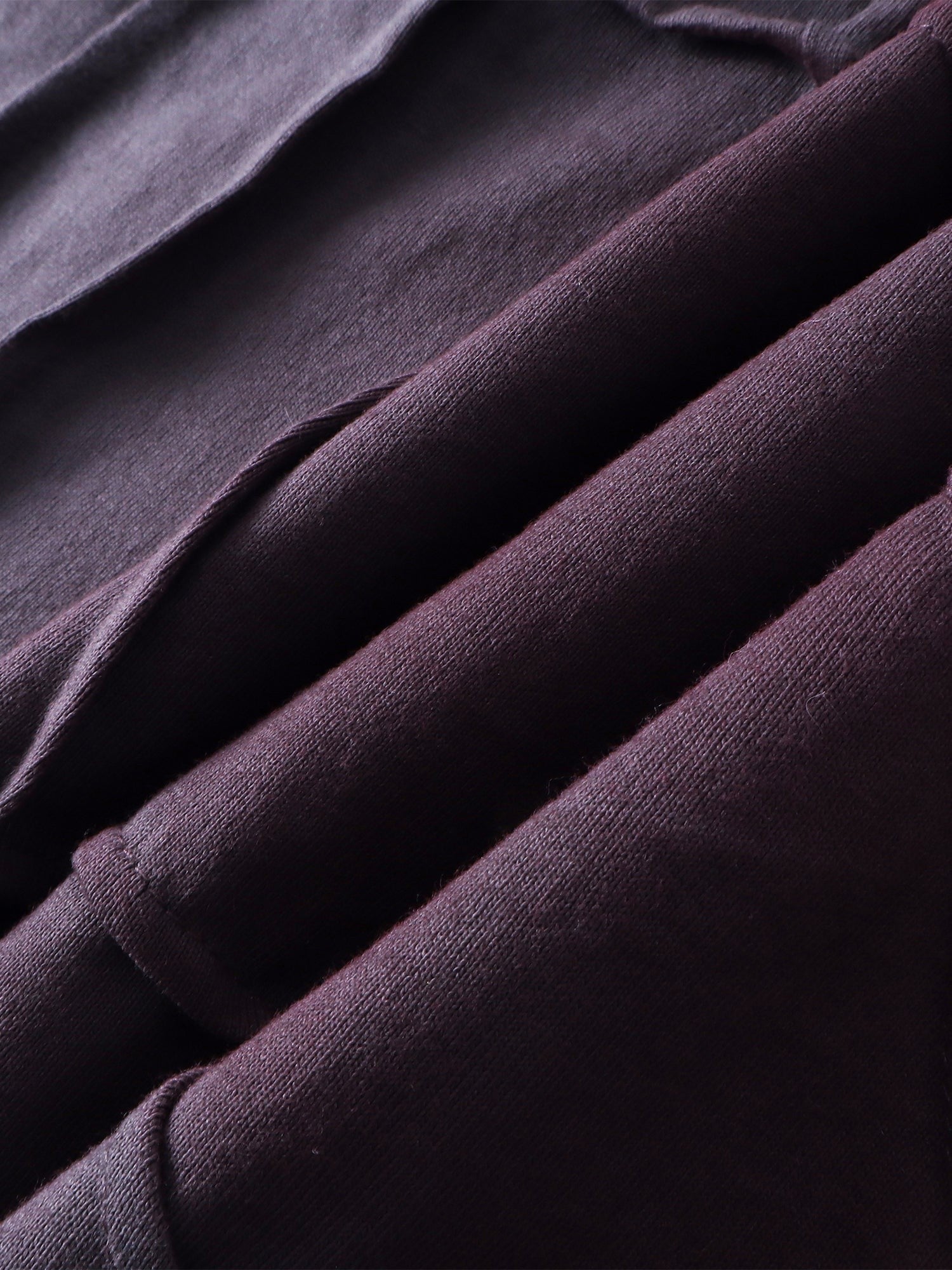 Close-up of the cotton fabric texture on TBHNP sword-and-bone tee — men's streetwear detail