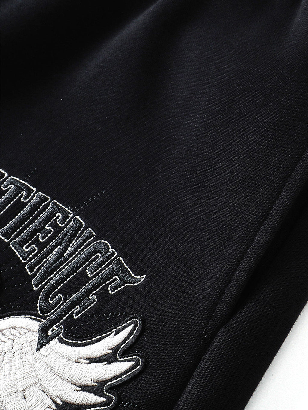 Raised eagle embroidery and tonal lettering texture close-up
