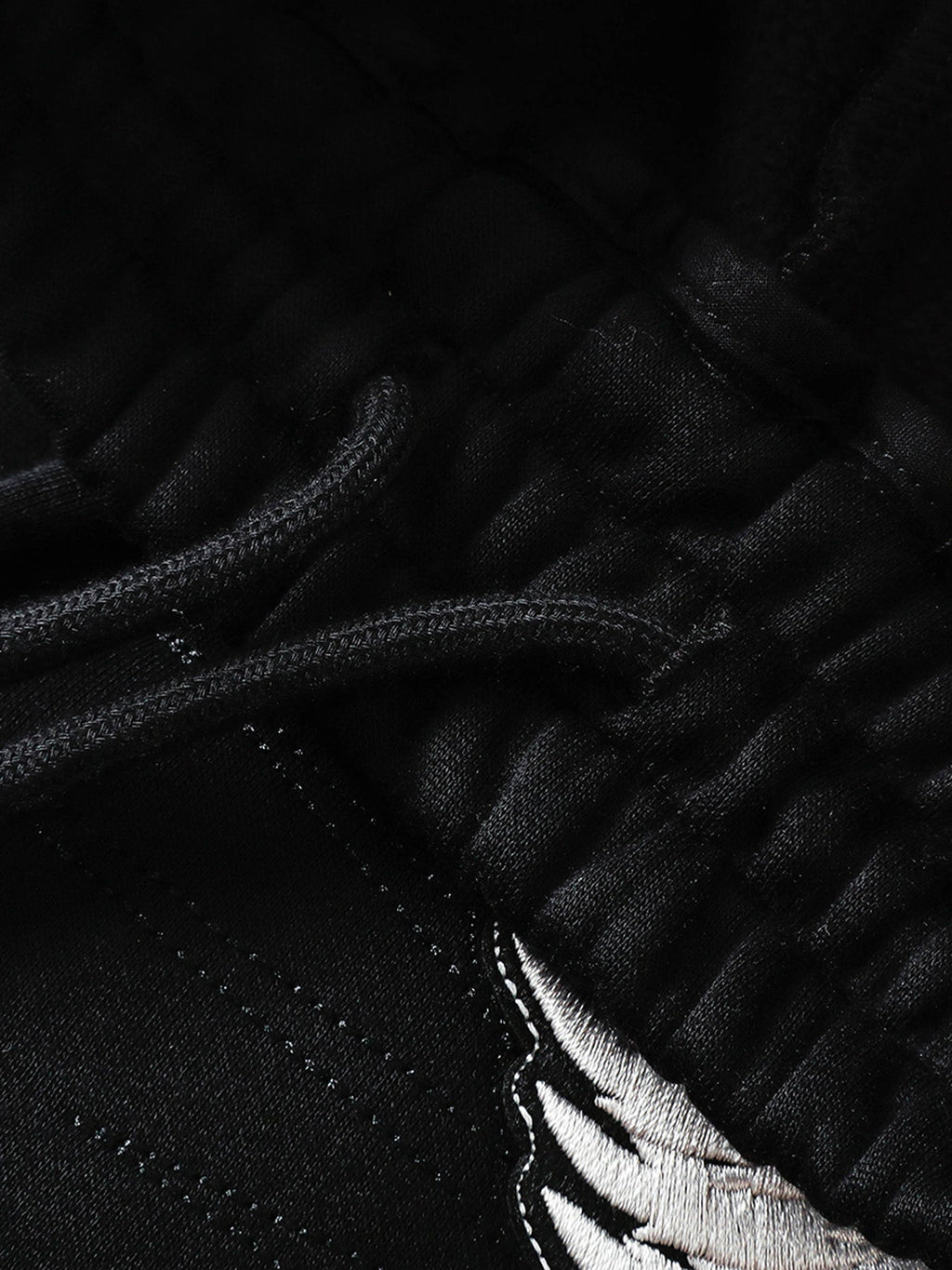 Black sweatpants pocket and reinforced seam detail