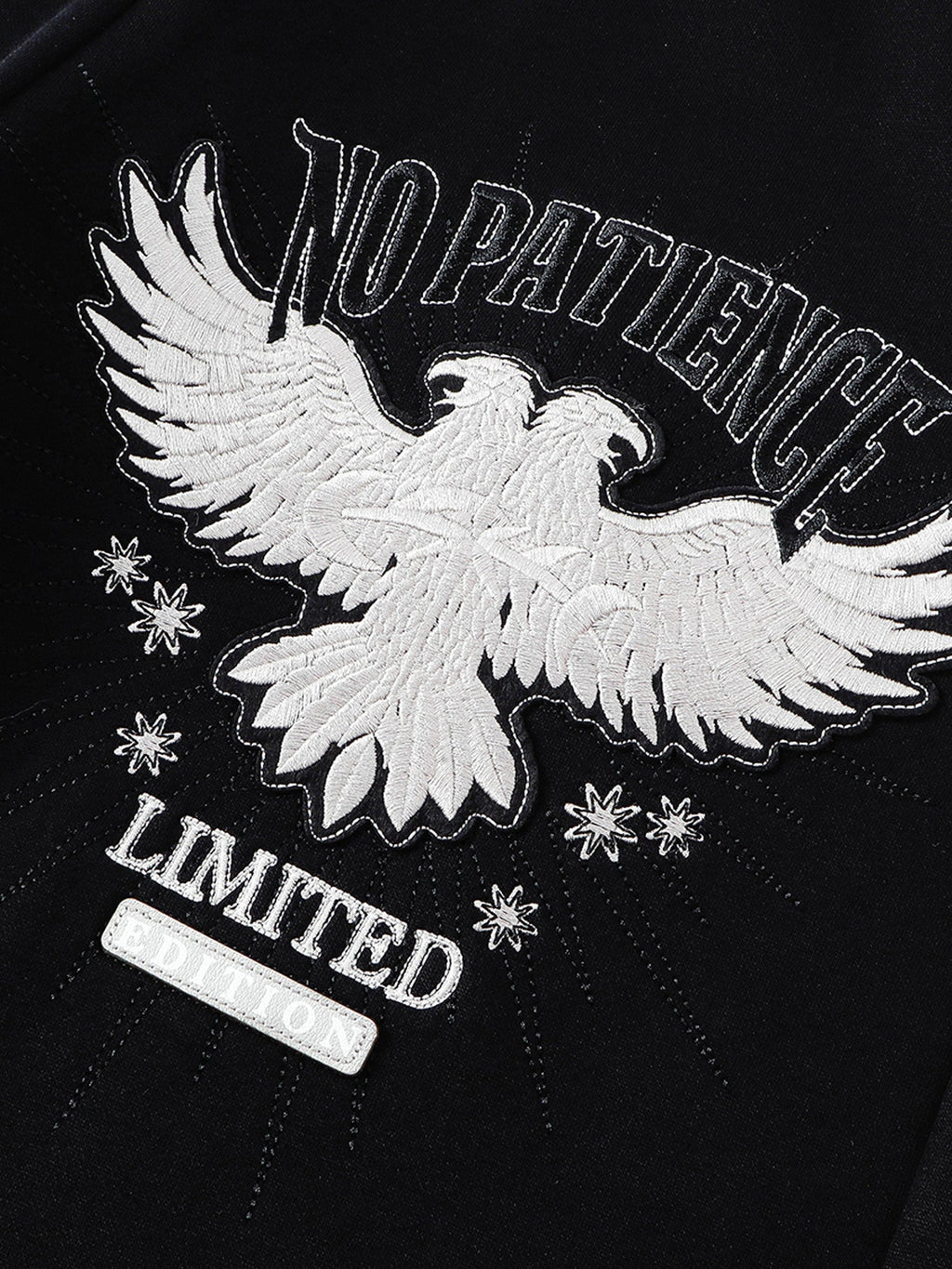 Double-headed eagle embroidery and Luminous Dawn lettering close-up