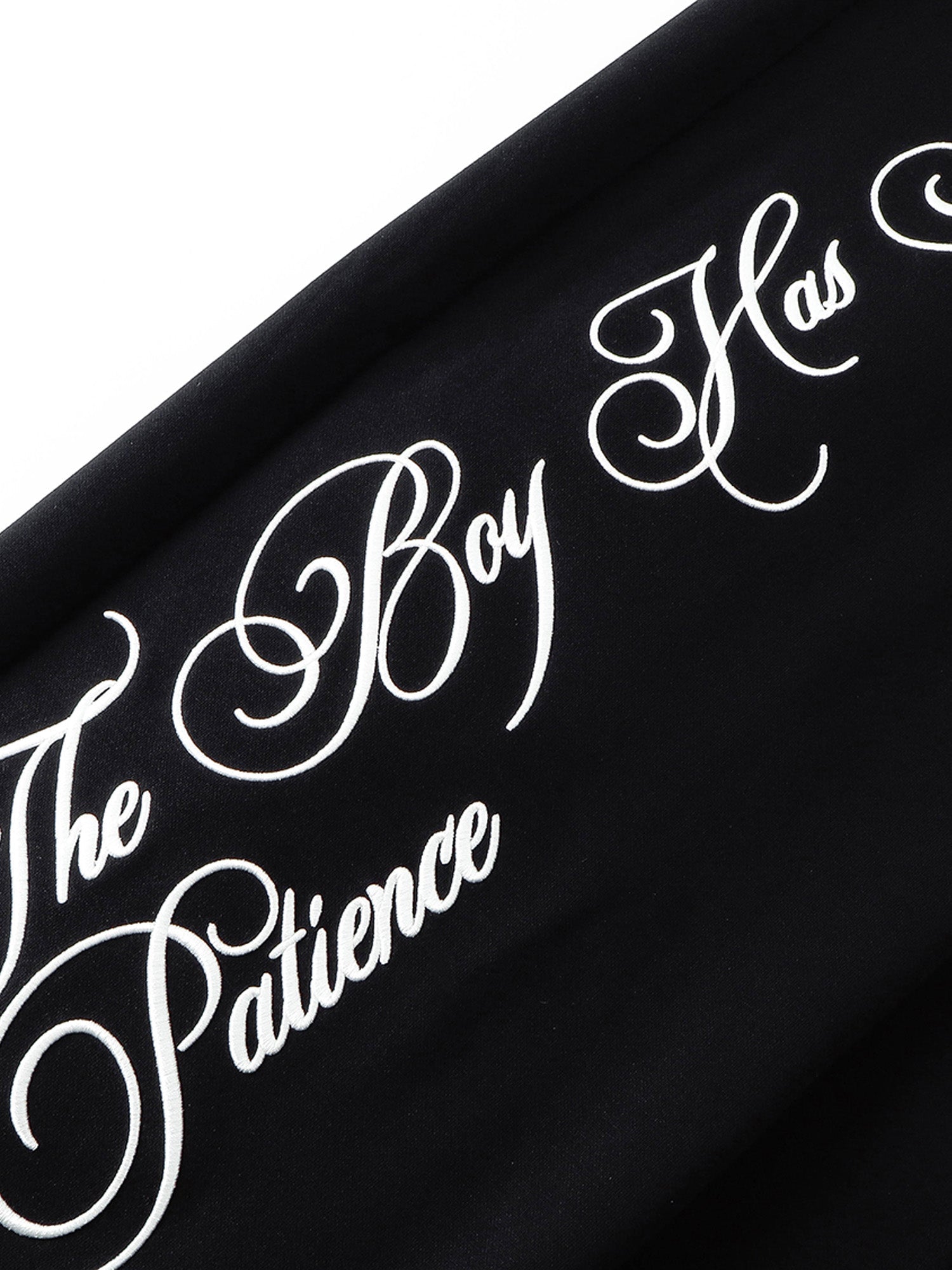 TBHNP gothic script graphic on black sweatpants leg