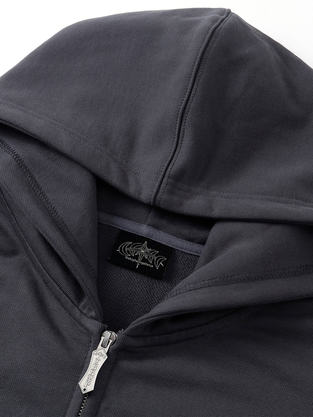 Close-up of the Black Leather Patch Zip Hoodie front panel construction.