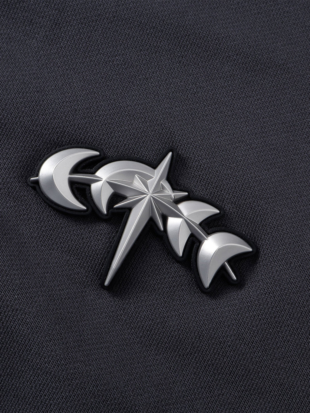 Close-up of the Black hoodie zipper and chest hardware.