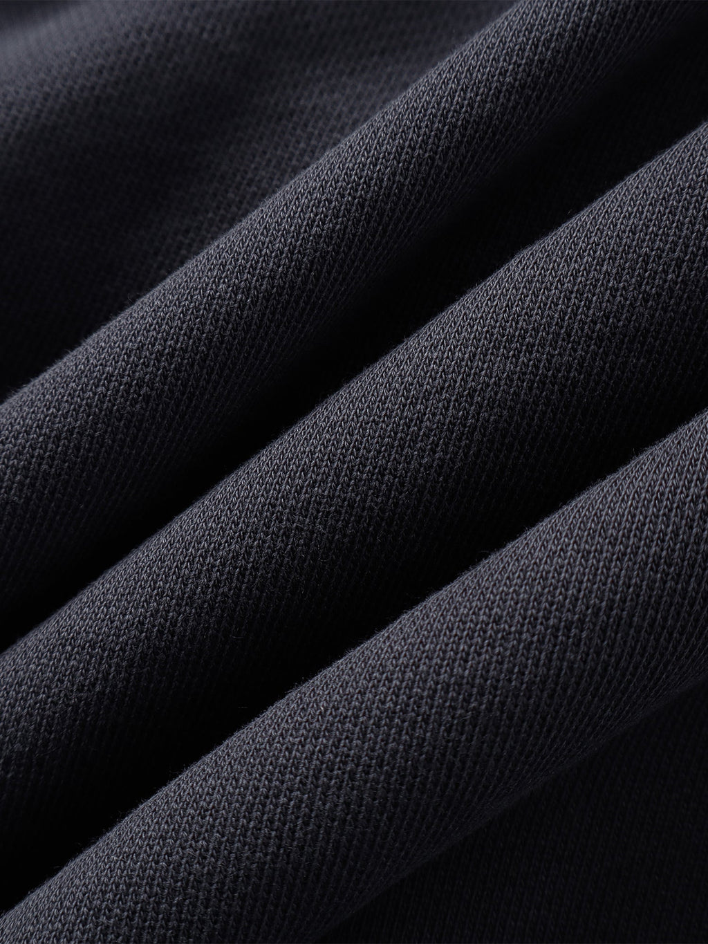 Close-up of the Black hoodie hem and seam finish.