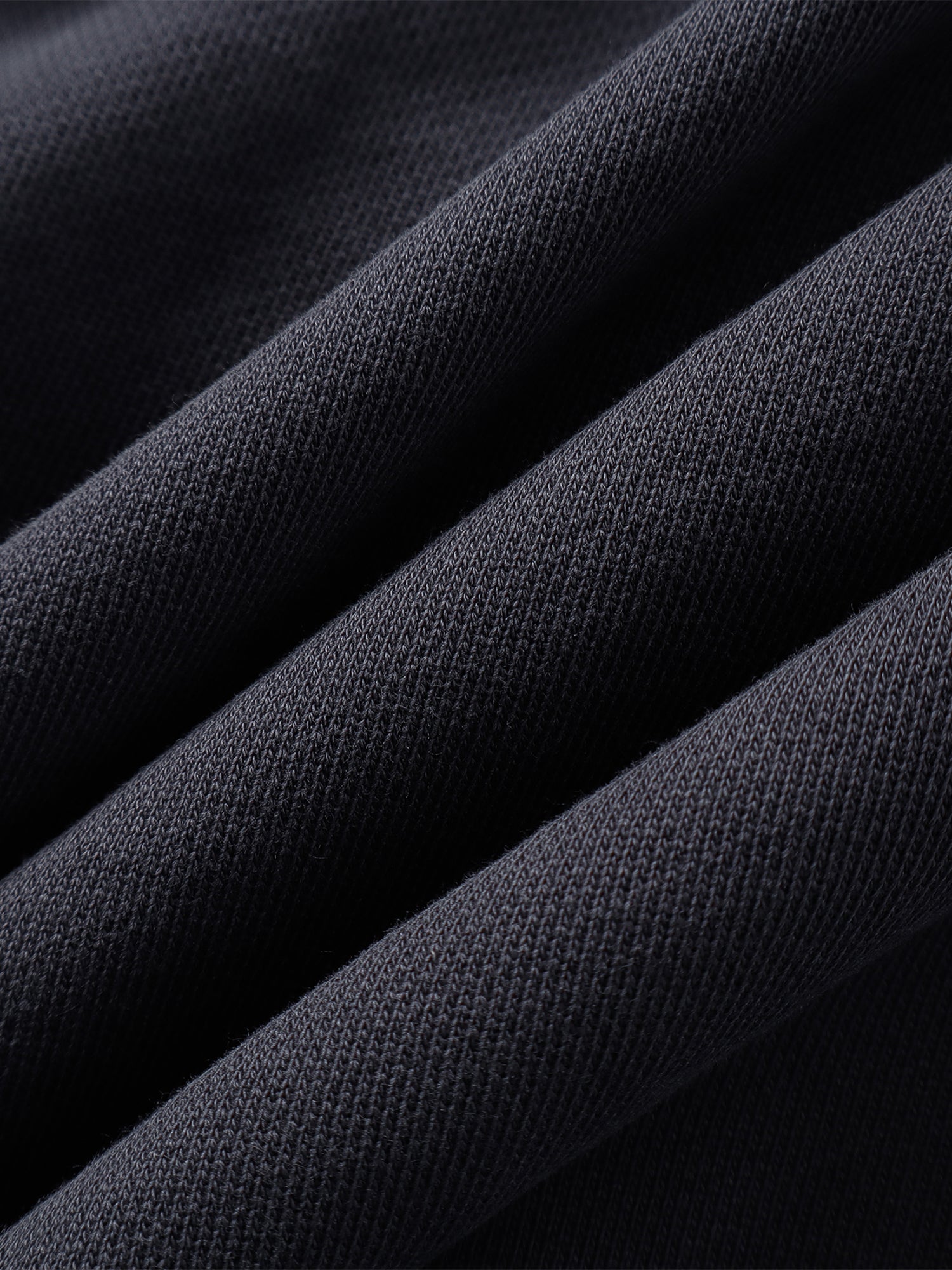 Close-up of the Black hoodie hem and seam finish.