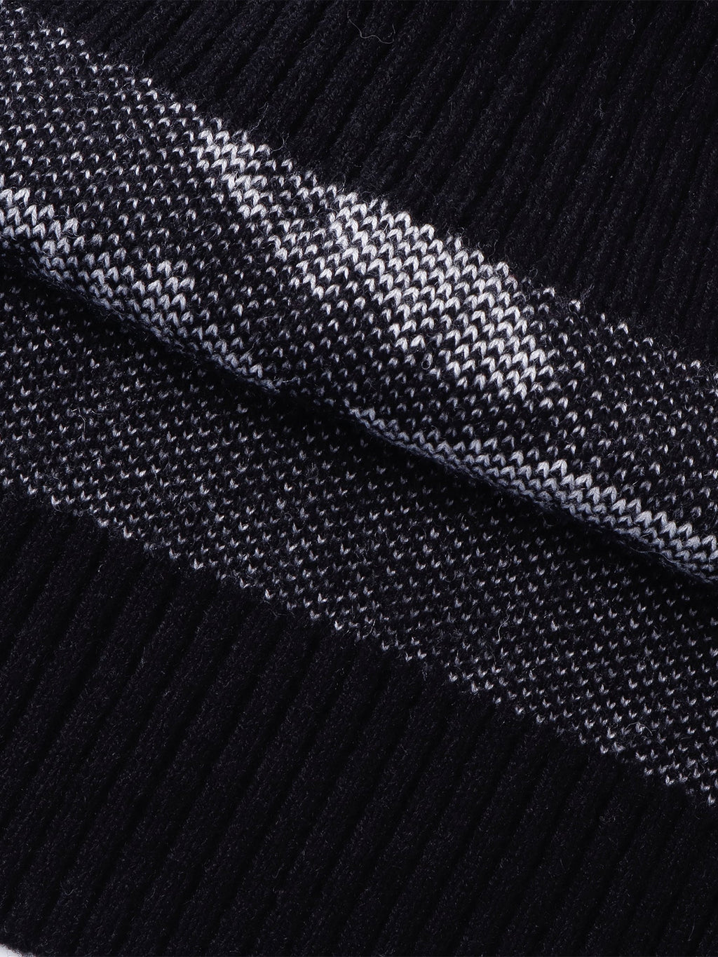 Close-up of the sweater vest armhole and jacquard construction.