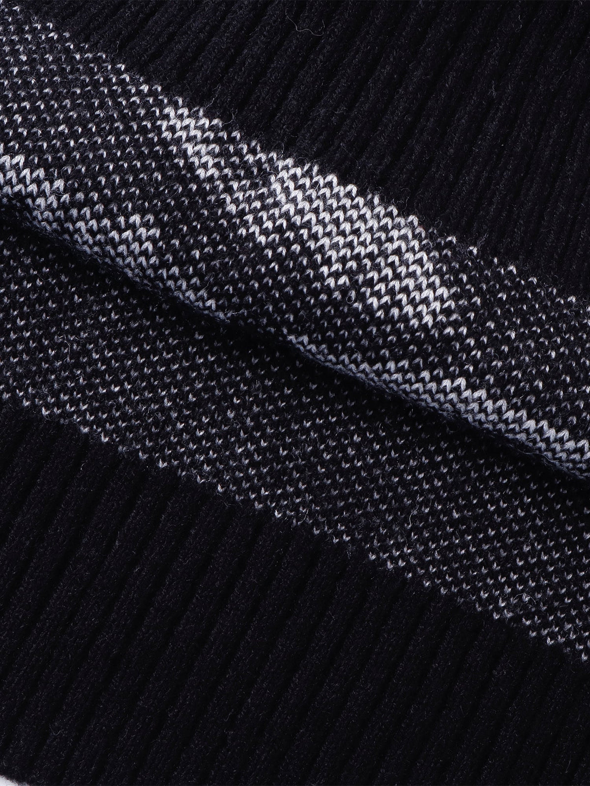 Close-up of the sweater vest armhole and jacquard construction.