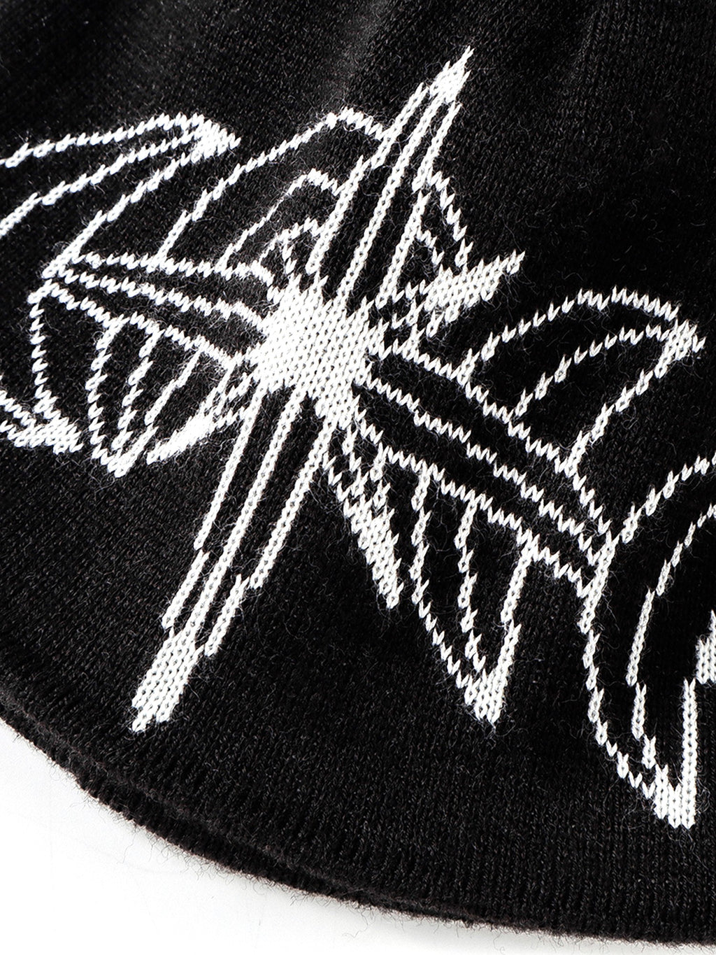 White jacquard star motif on Black beanie, close-up