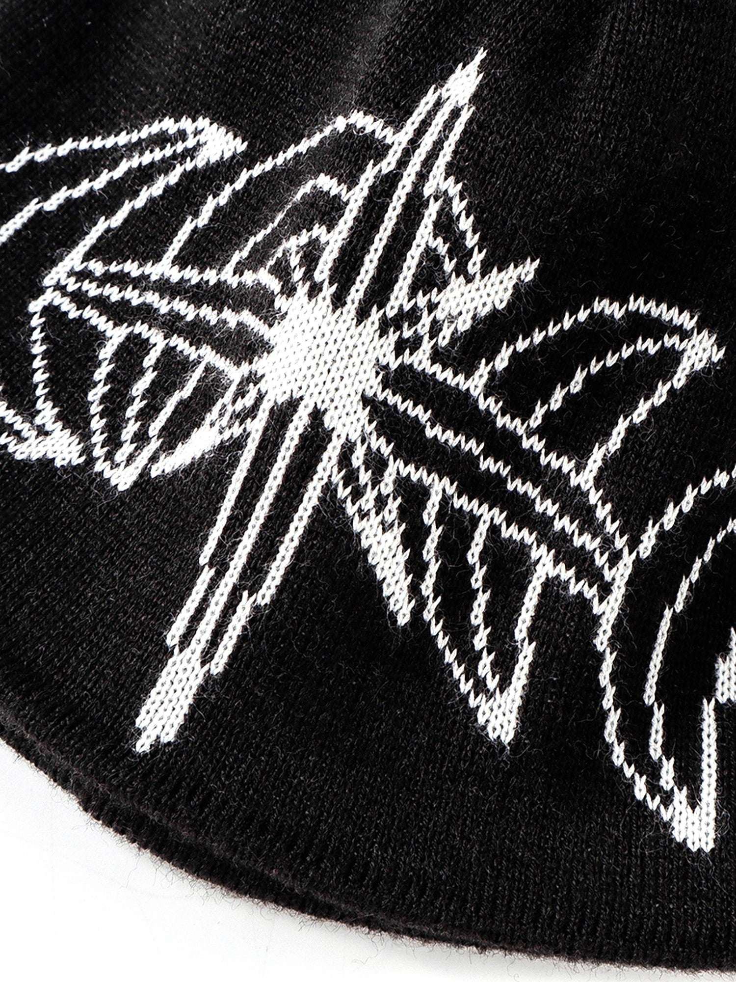 White jacquard star motif on Black beanie, close-up