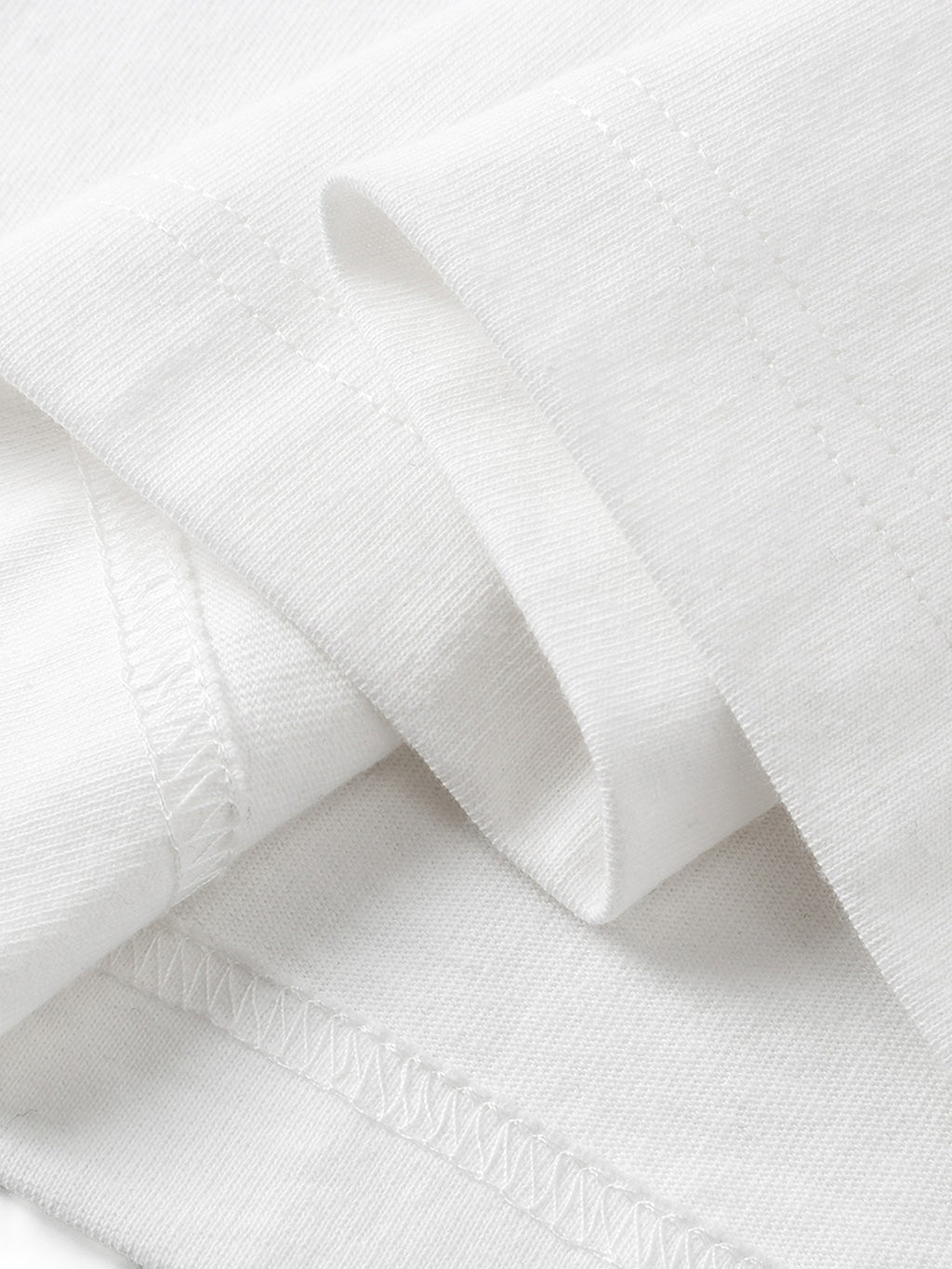 White long-sleeve tee hem and overlock seam detail