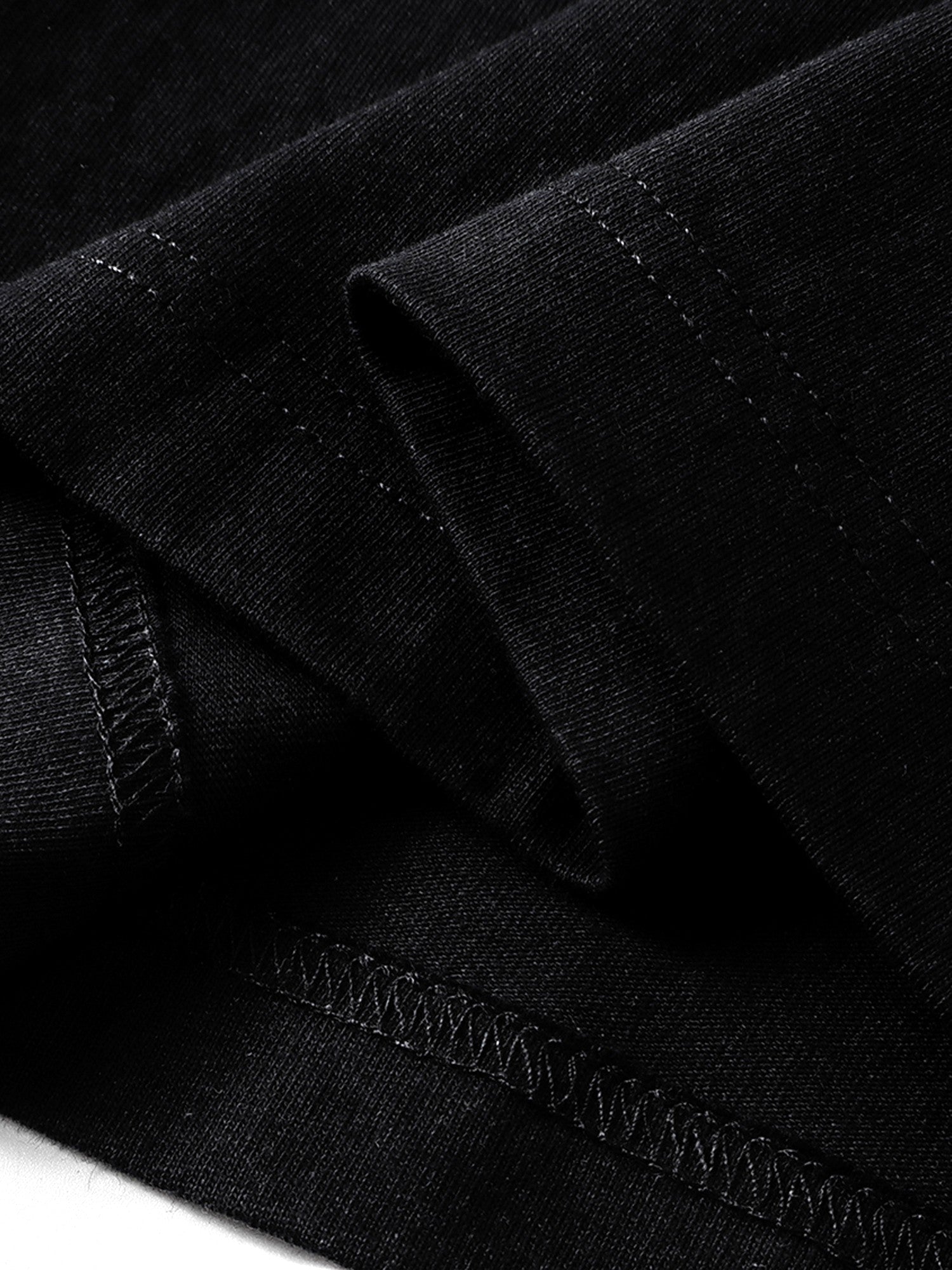 Black long-sleeve tee hem and overlock seam detail