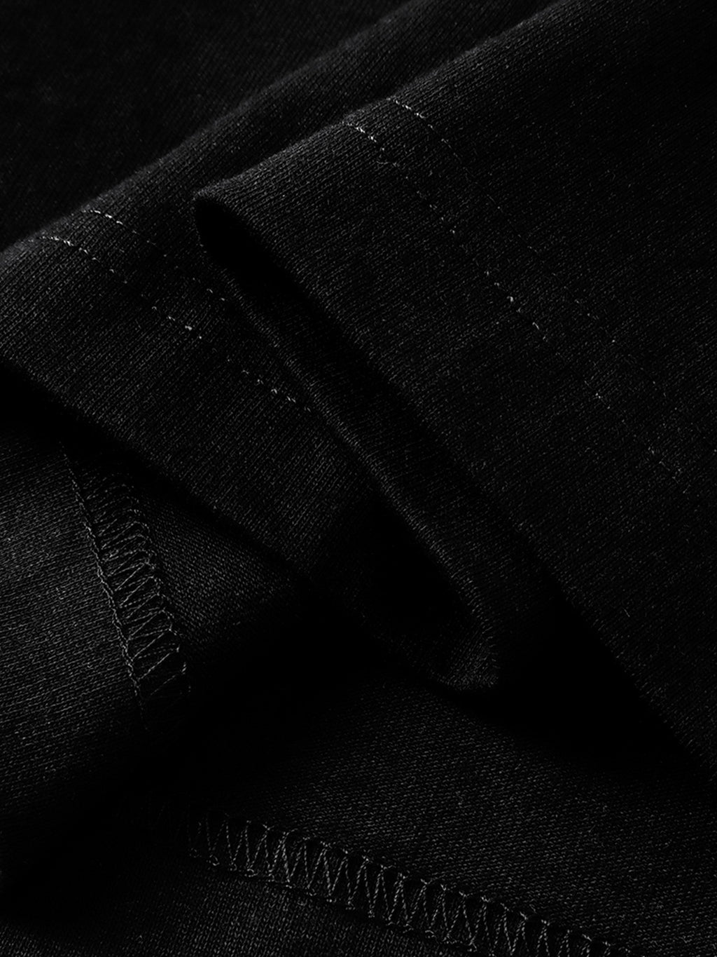 Black long-sleeve tee hem and overlock seam detail