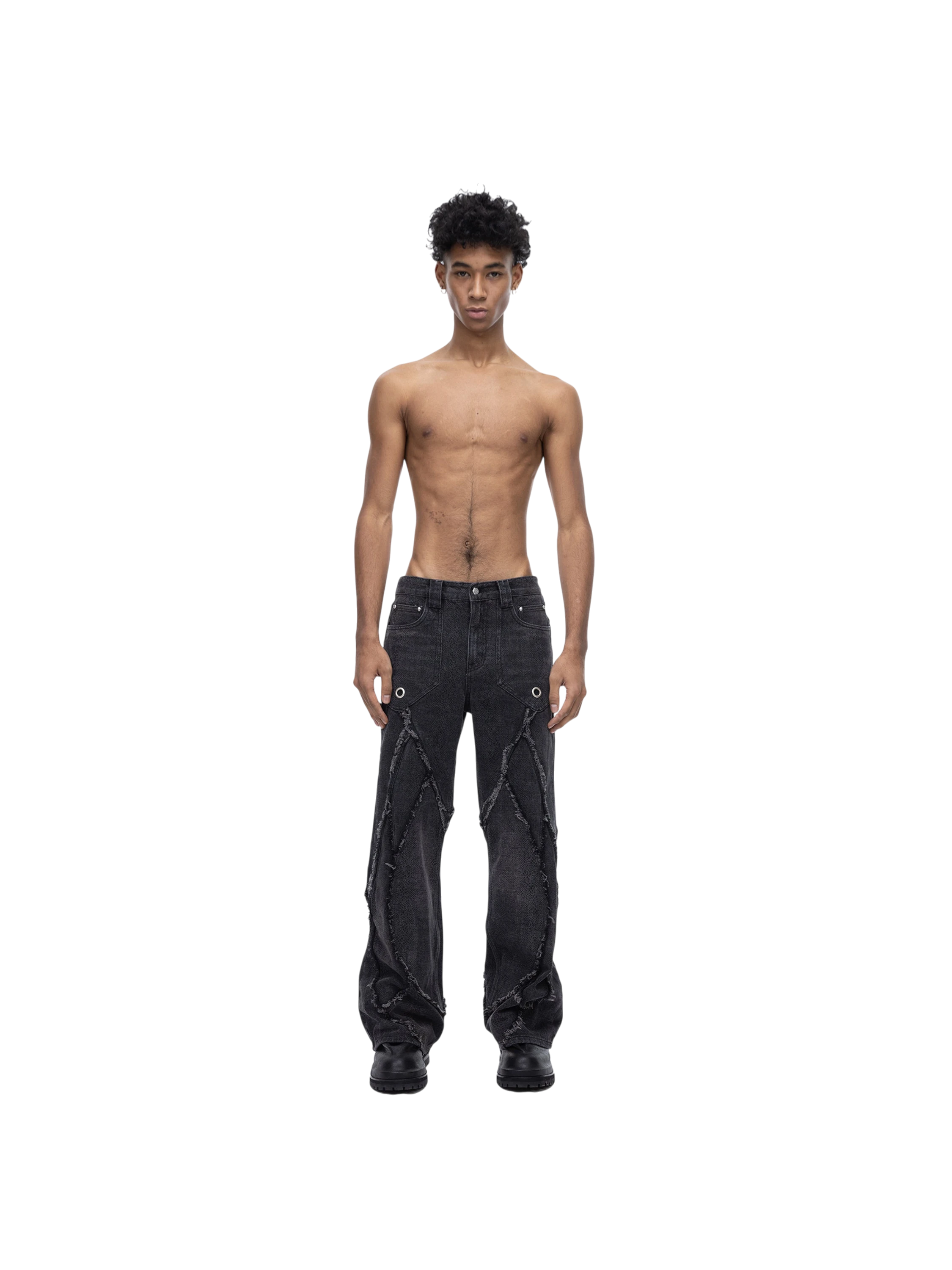 Male model wearing TBHNP black baggy jeans, side-back view — men's streetwear denim