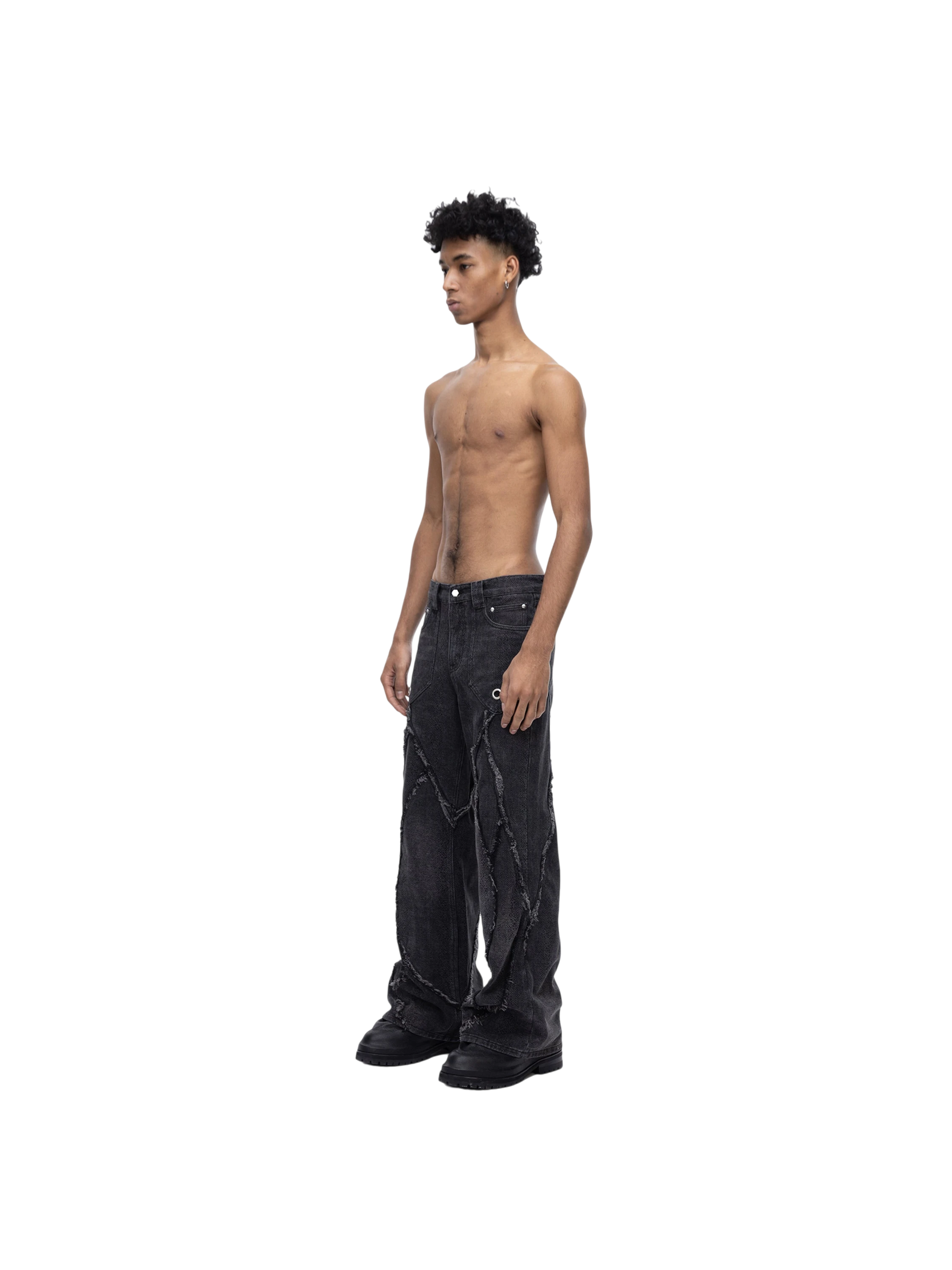 Male model wearing TBHNP black cobra print baggy jeans, full-length front — men's streetwear