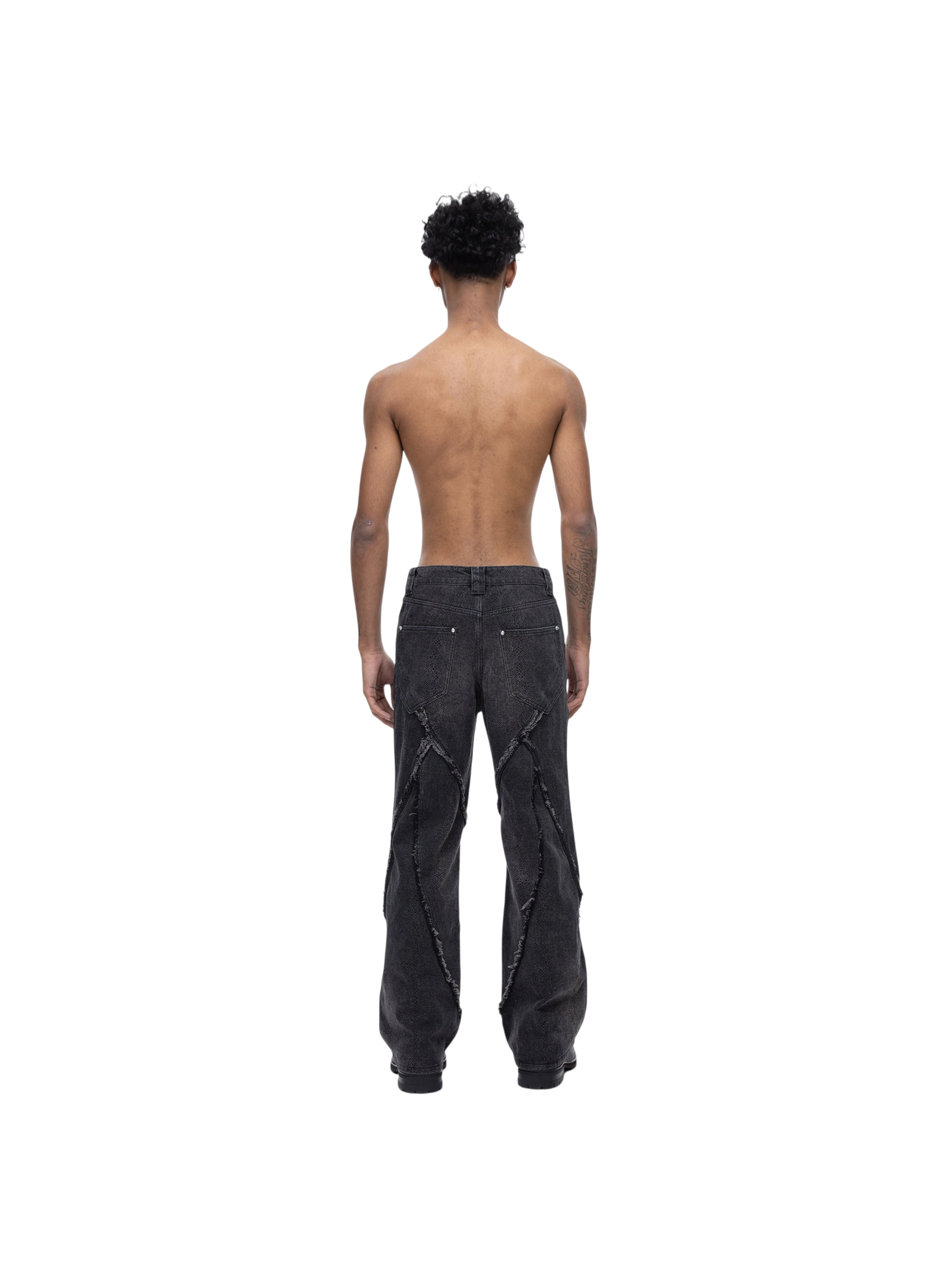 Male model in TBHNP cobra print baggy jeans, front — men's streetwear denim