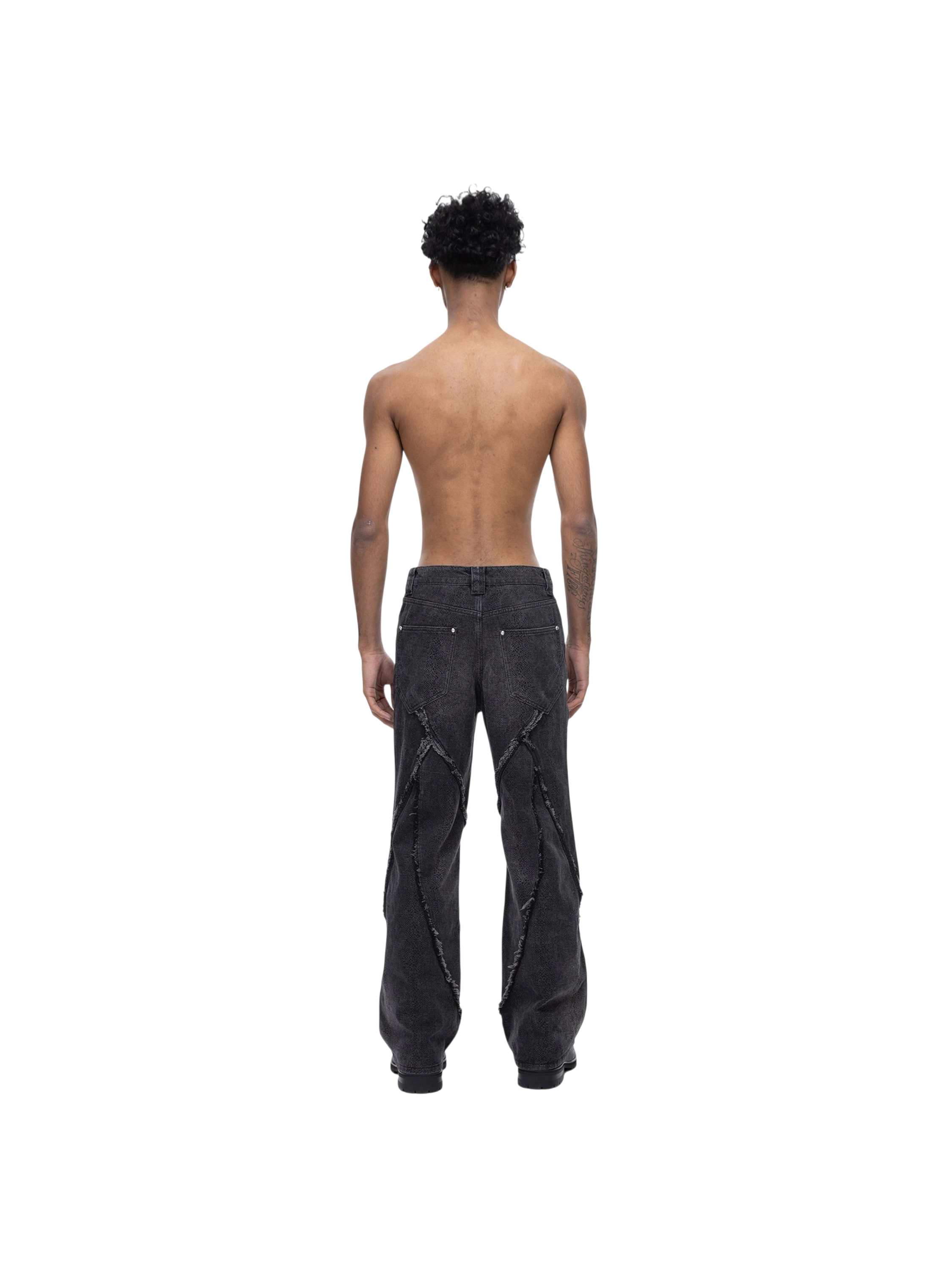 Male model in TBHNP cobra print baggy jeans, front — men's streetwear denim