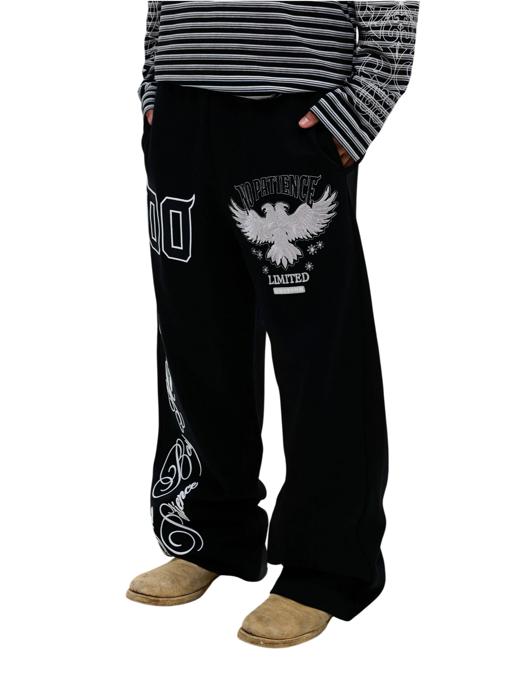 Model wearing black Luminous Dawn embroidered sweatpants, three-quarter view