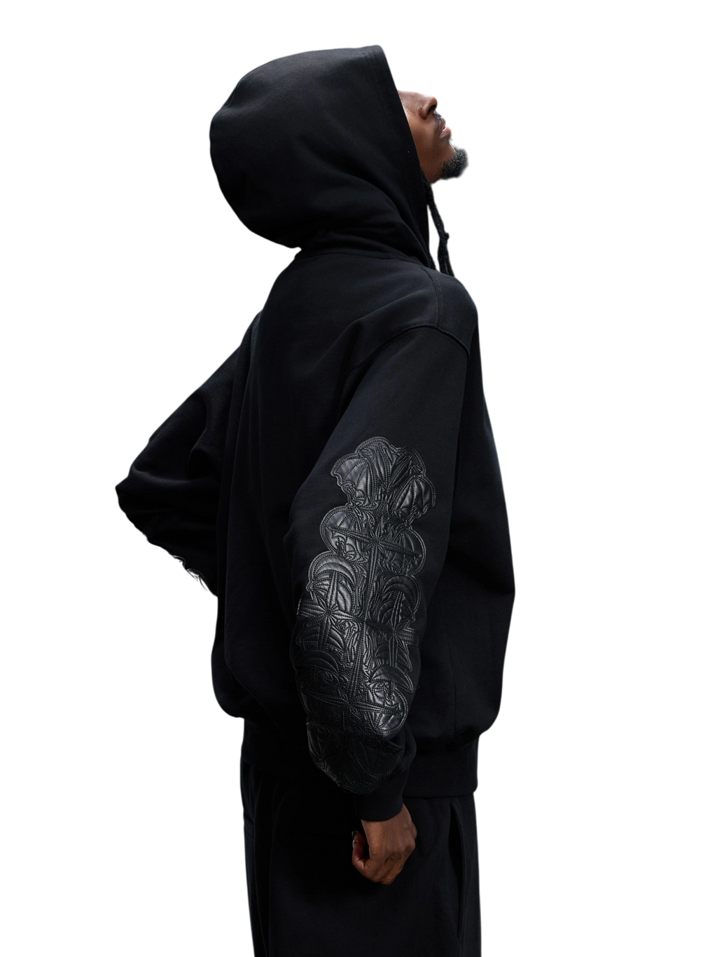 Model wearing the black Leather Patch Zip Hoodie, side view.