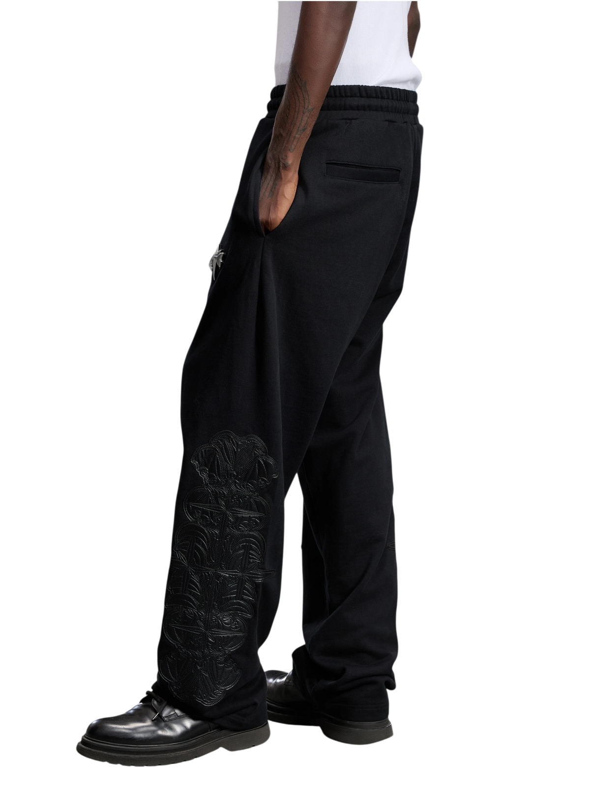 Model wearing the black Leather Patch Pants, side view.