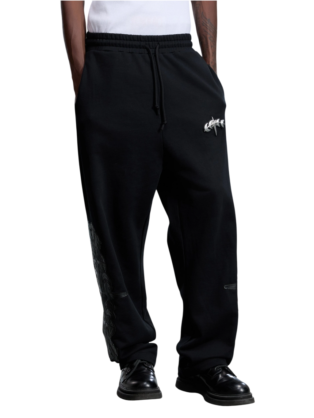 Model wearing the black Leather Patch Pants, angled front view.